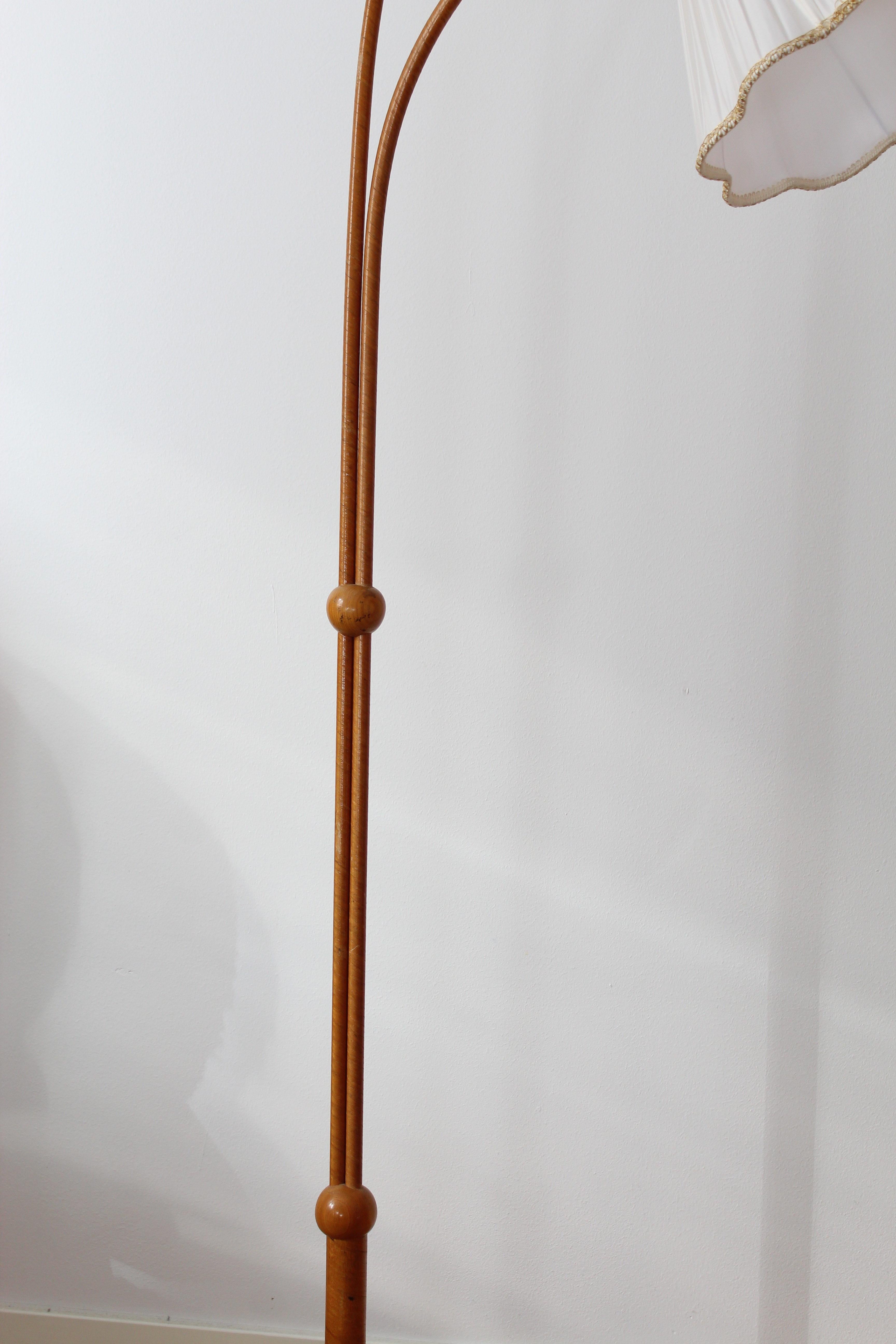 An organic three-armed floor lamp. Designed by an unknown Swedish modernist designer, 1930s. Possibly manufactured by Böhlmarks. Produced in, wood, fabric, and brass. 

Other designers working in the organic style include Jean Royere, Gio Ponti,