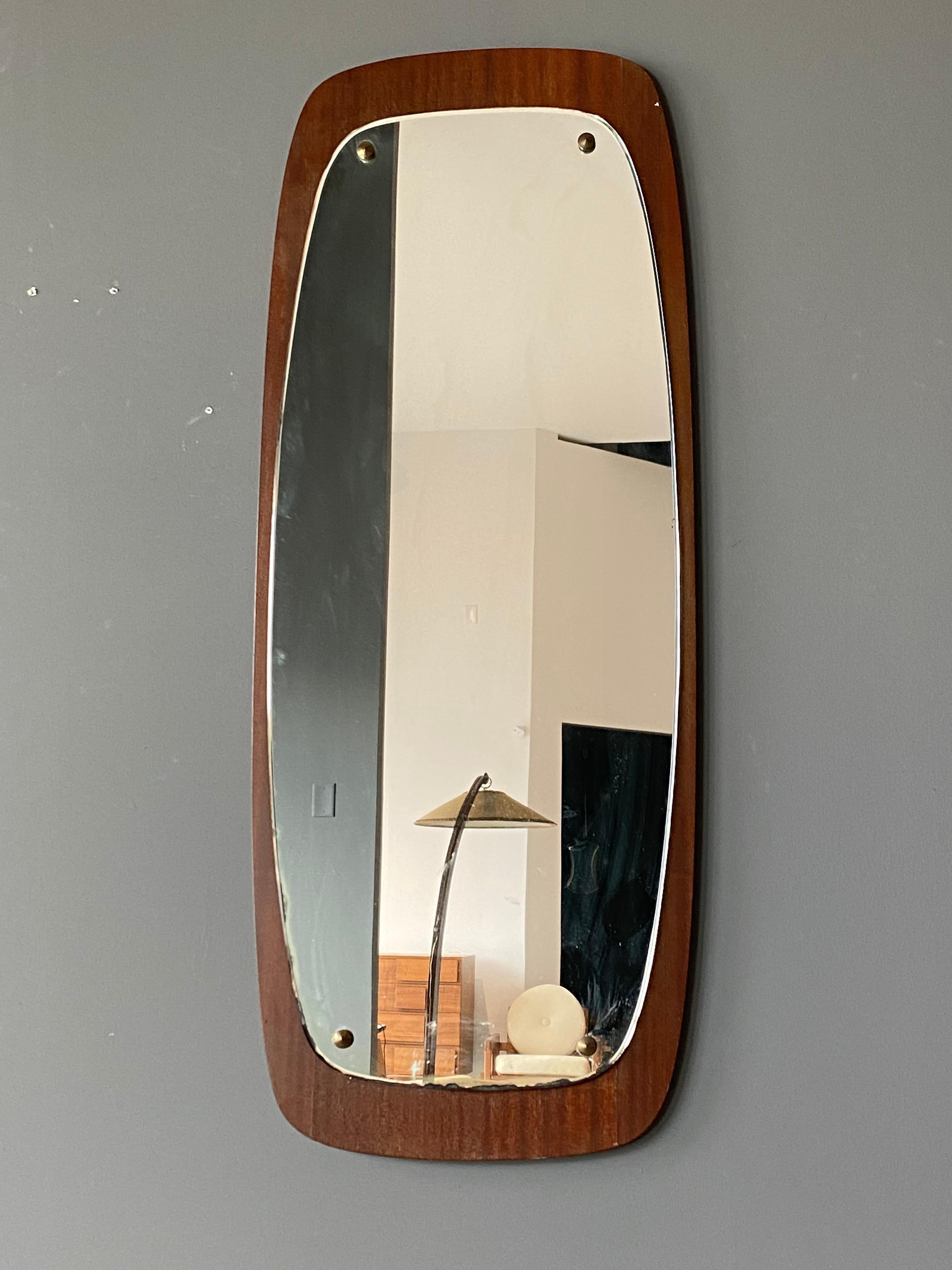 A Swedish organic modern mirror. Original mirror glass mounted on teak frame with visible brass plugs.

Other designers of the period include Finn Juhl, Campo Graffi, Fontana Arte, Josef Frank, and Hans Agne Jacobsen.