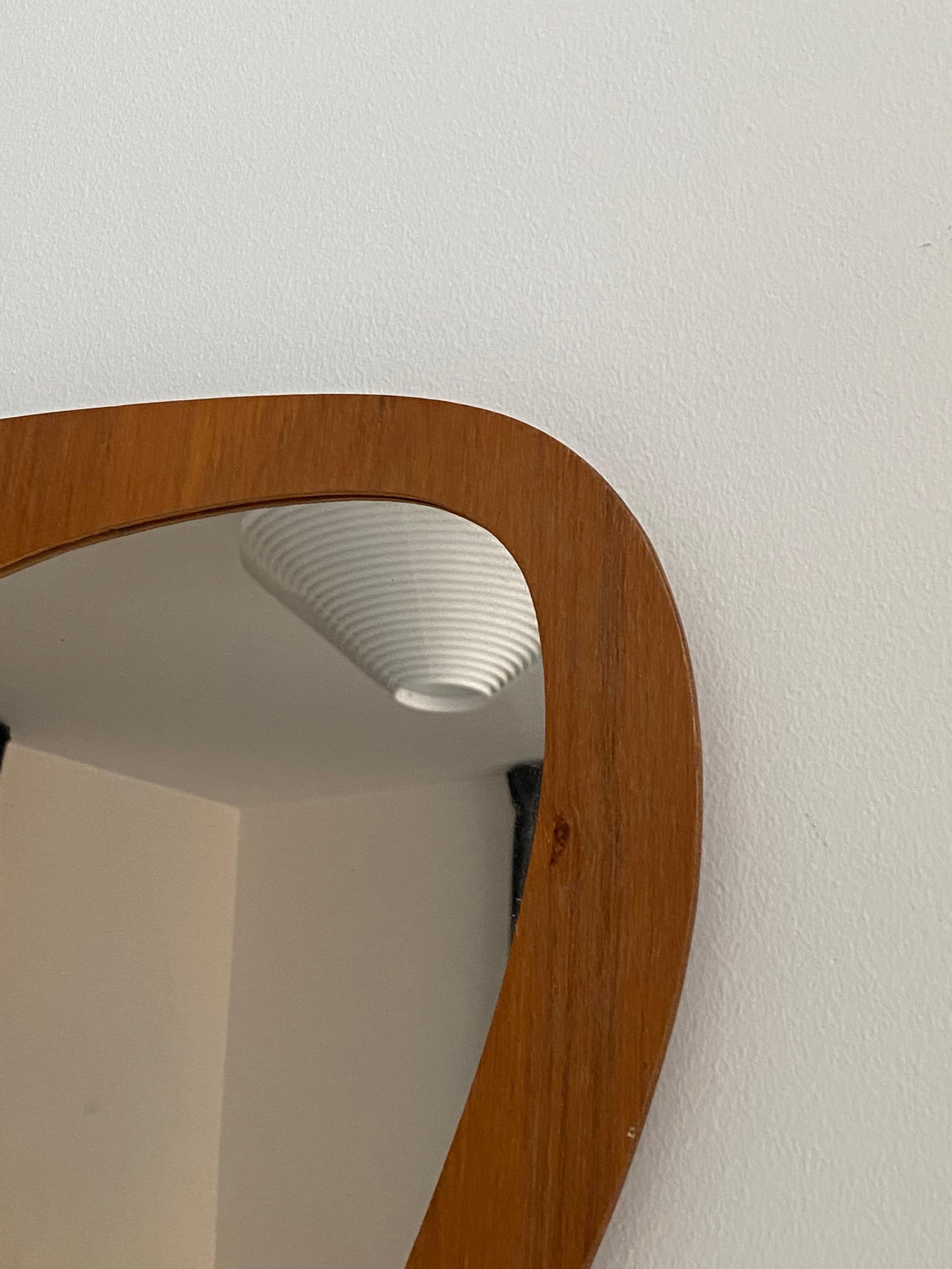 An organic wall mirror. Designed and produced in Sweden, c. 1950s-1960s.

 