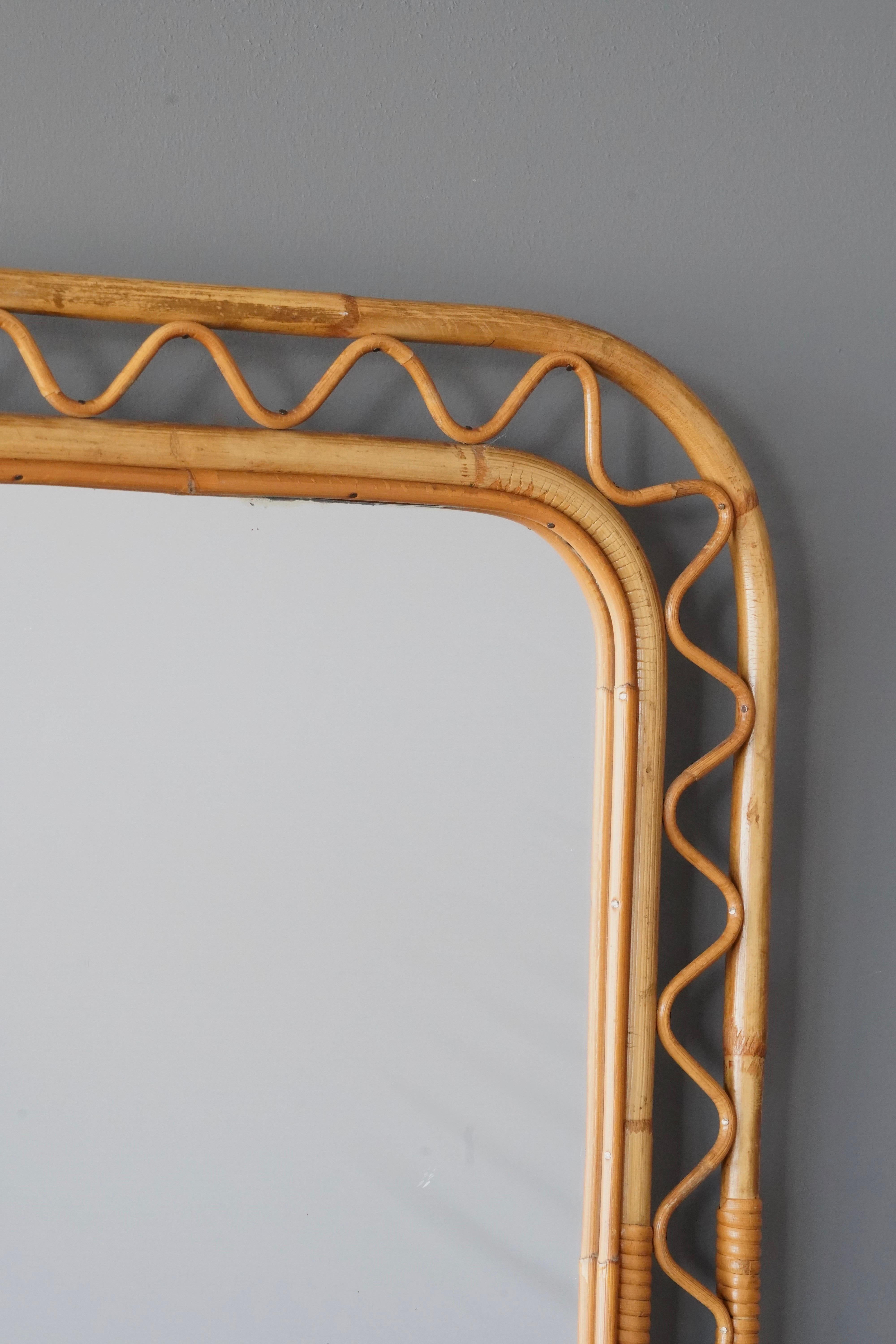 An organic mirror, of unknown Swedish production. Similar mirrors retailed by Svenskt Tenn, the iconic Swedish firm founded by Estrid Ericson and creatively led by Josef Frank. 

In finely braided wicker / rattan / cane and bambo.

Other