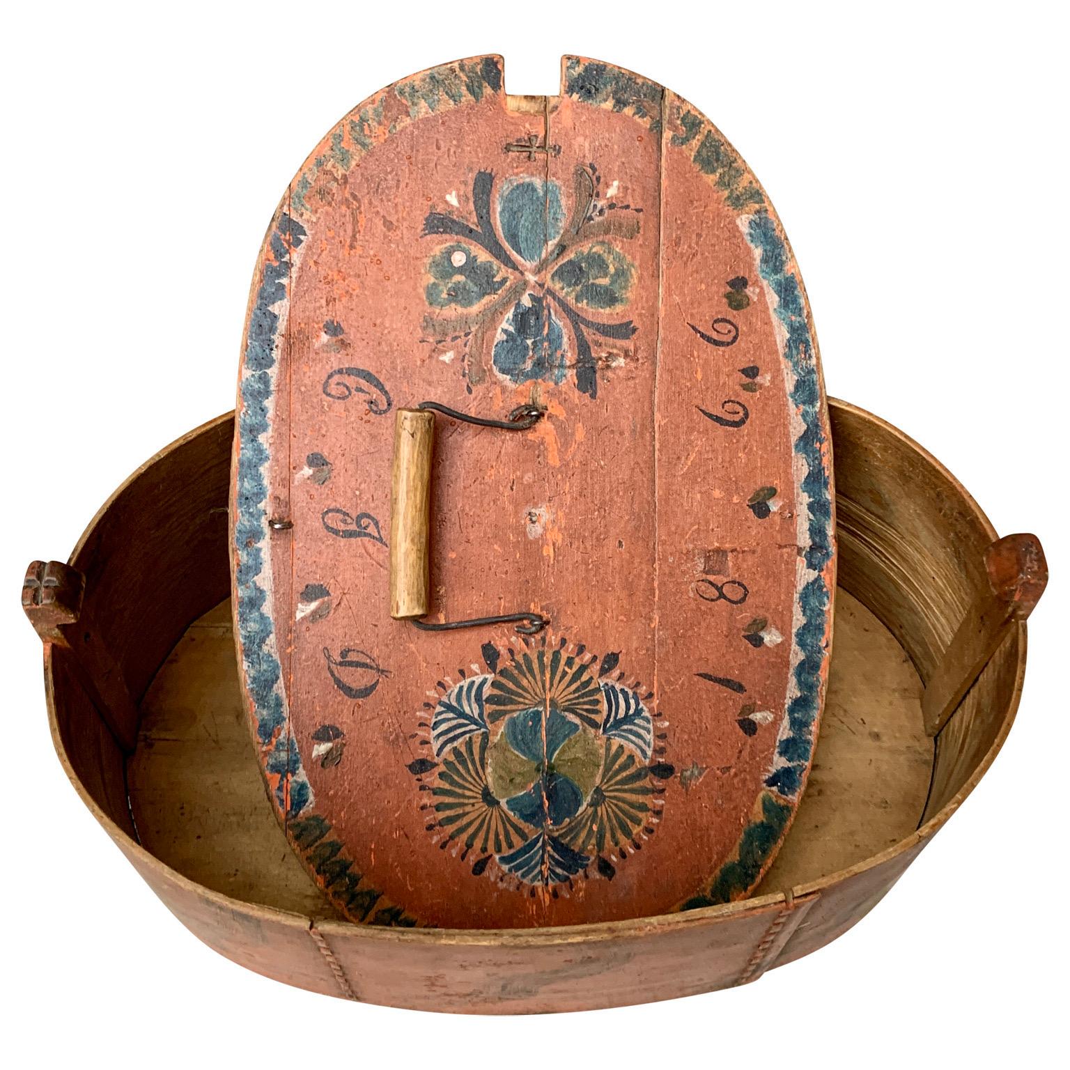 A  19th Century original painted decorative box from the region of Jämtland in Sweden, close to the mountain that separates the two Scandinavian countries Norway and Sweden. These types of boxes are usually used to bring food out in the fields or