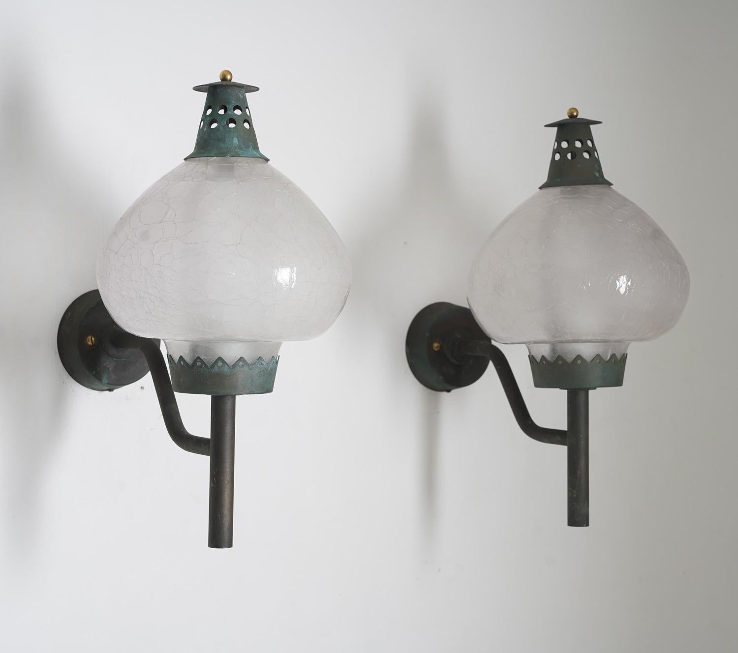 Pair of rare outdoor wall lamps in copper and glass by Hans-Agne Jakobsson, Sweden
These lamps are made of solid copper with glass shades. On top of the shades is a perforated copper hat, keeping the shade in place. 
Condition: Fantastic patina on