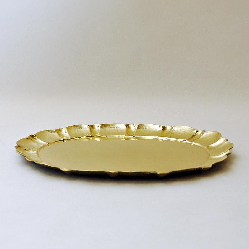 Lovely mid-century oval brass tray with nice edge decoration all the way around by Lars Holmström, Arvika Sweden 1950s. For decorative wall hanging or as a dish at the table for fruits, cakes, vegetables etc. Measures: 32.5cm W x 2cm H x 43 cm
