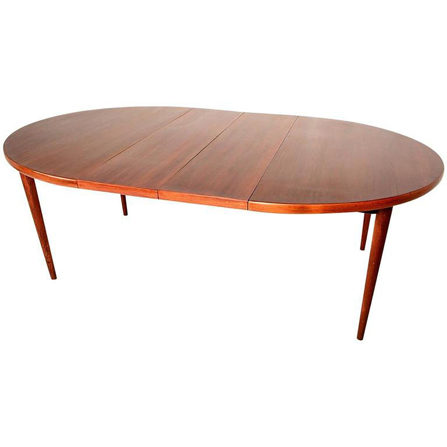 For your consideration an oval dining table in teakwood with two extensions. 

Legs can be removed for safe and easy shipping. 

Stamped underneath: 
