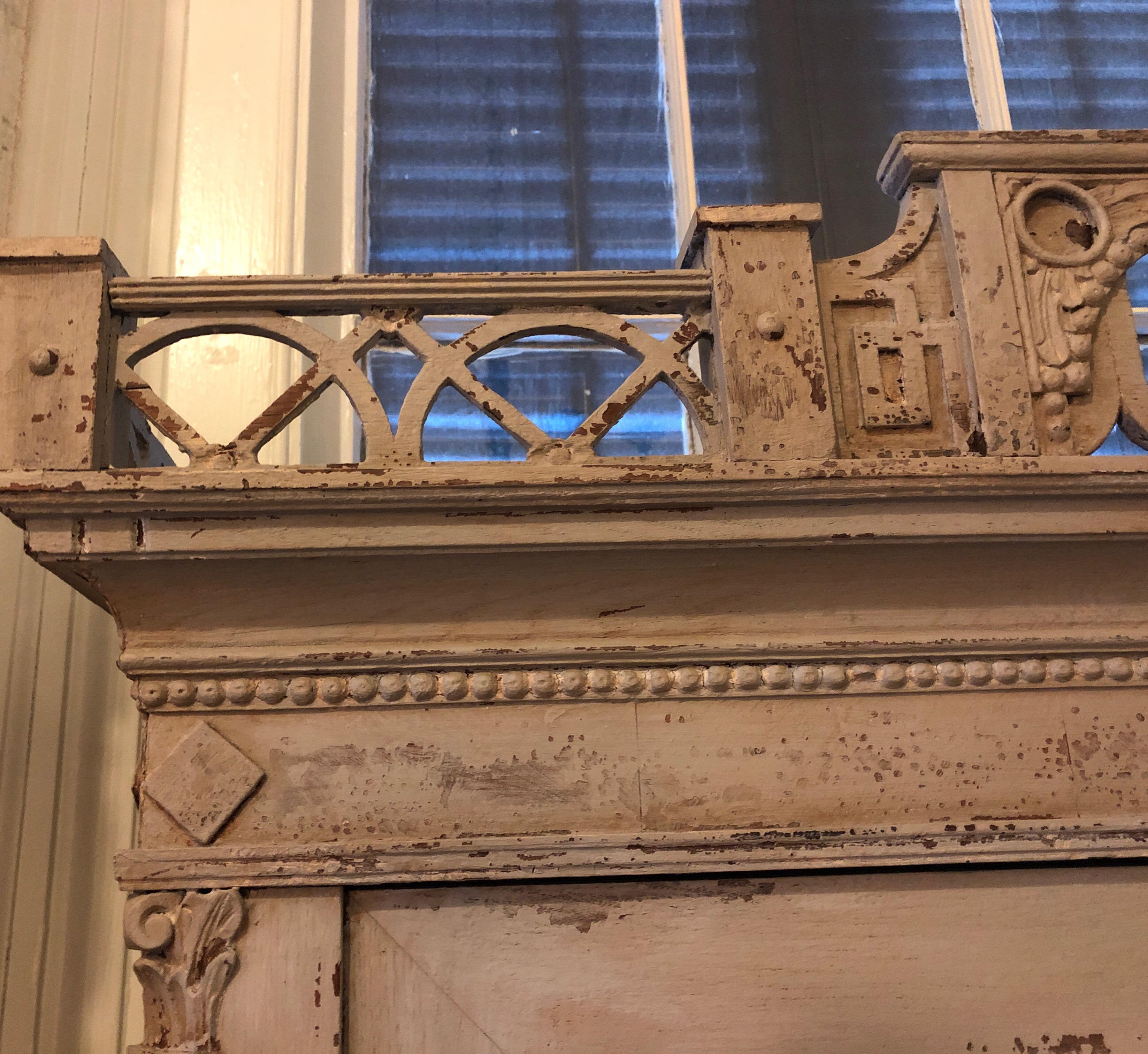 18th century painted Swedish bookcase secretary. Having a Louis XVI style pierced pediment and block front. With two doors a fall front and three drawers.