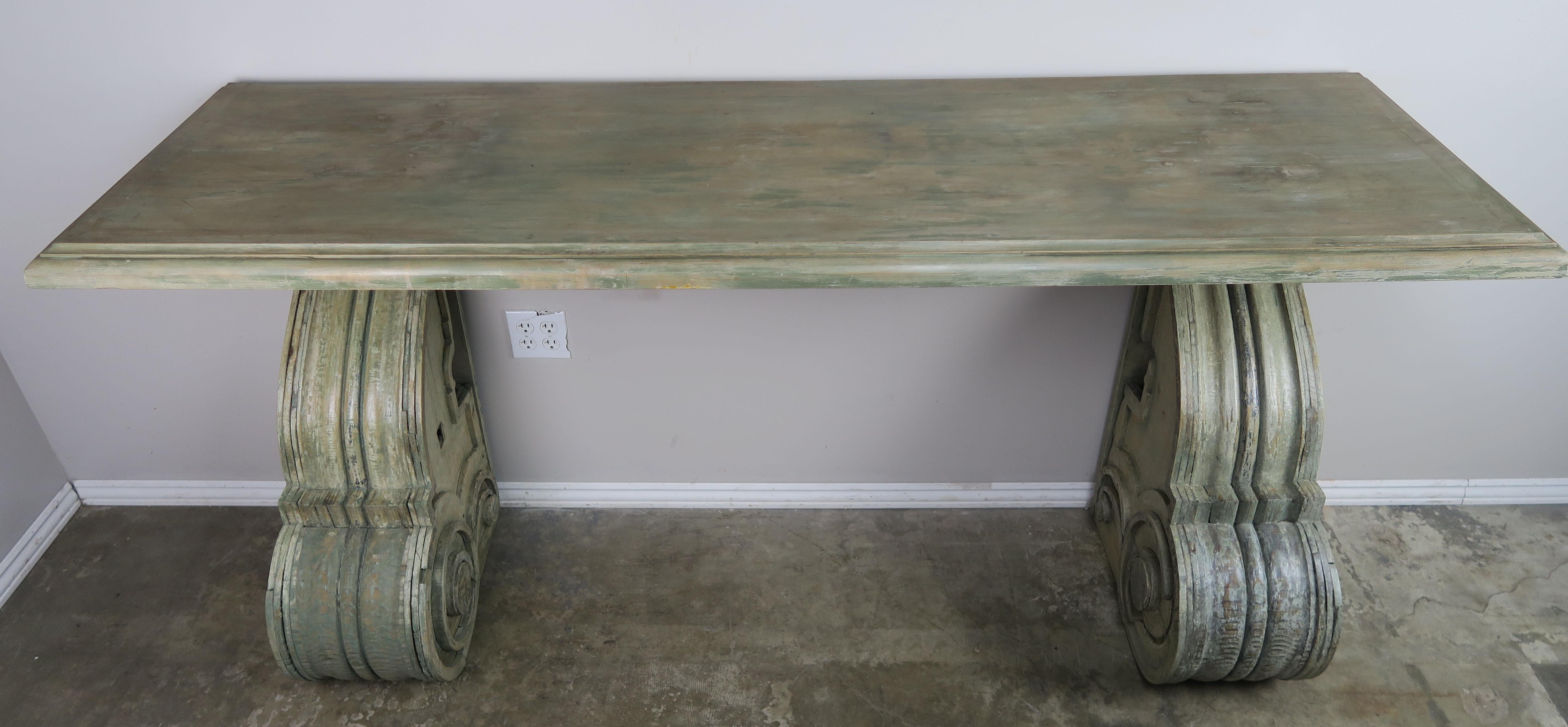 Swedish painted sideboard that includes one solid piece of wood supported by two large 19th century celadon painted corbels. Paint beautifully worn to expose wood underneath.
 