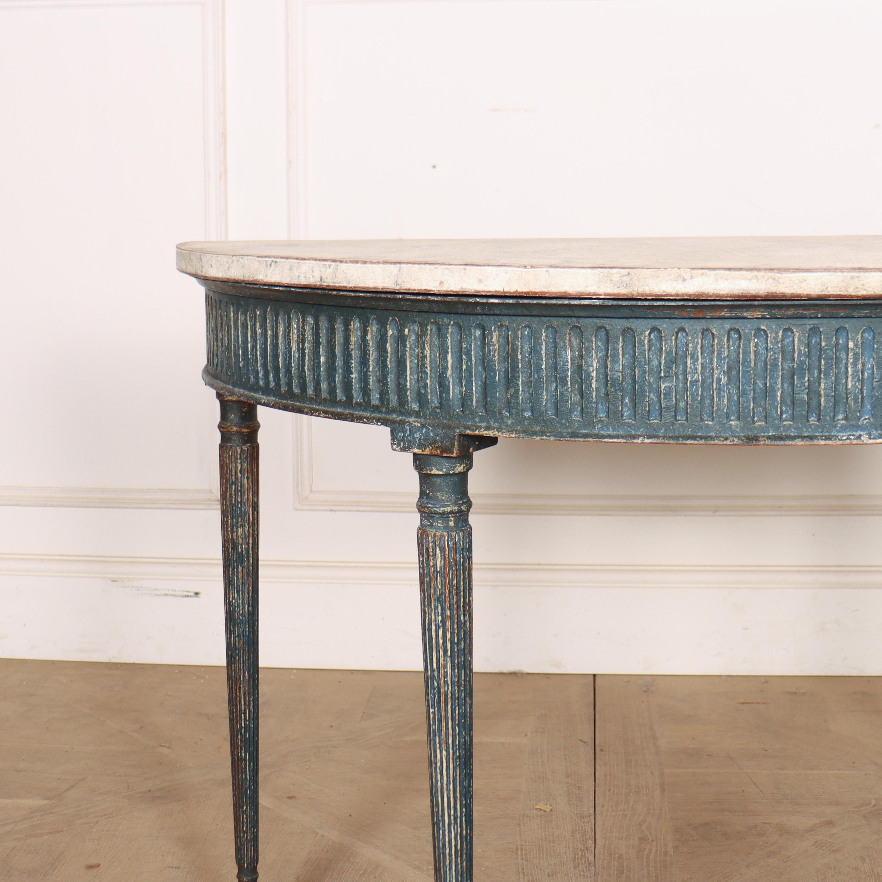 Small 19th century Swedish painted demi-lune pine console table with fluted legs and a faux marble top. 1830. 


Code: 9089

Dimensions:
W: 39