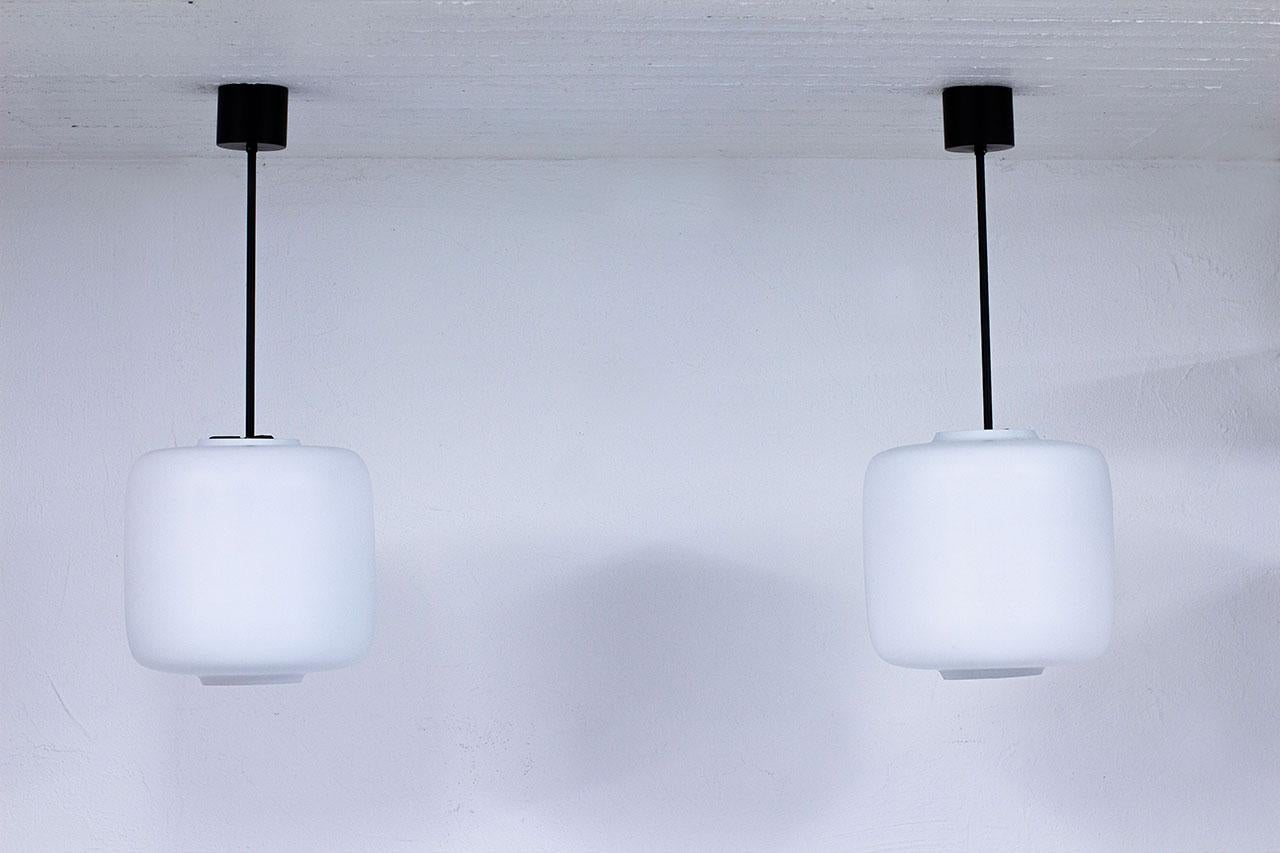 Swedish Pair of Black Metal & White Matte Opaline Glass Pendant Lamps, 1950s In Good Condition For Sale In Stockholm, SE