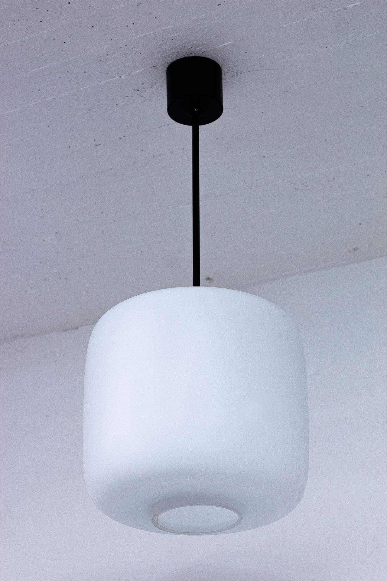 20th Century Swedish Pair of Black Metal & White Matte Opaline Glass Pendant Lamps, 1950s For Sale