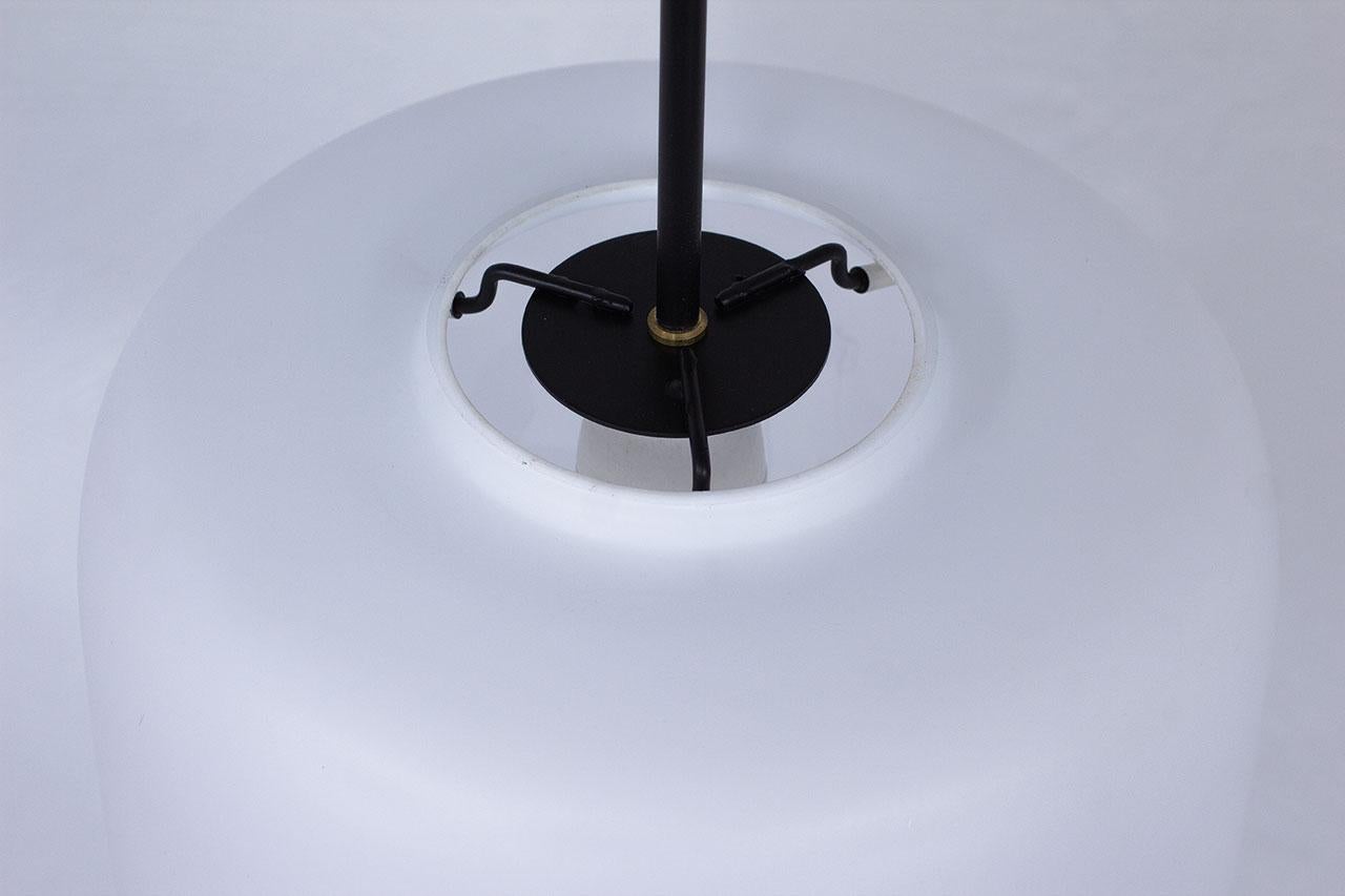 20ième siècle Paire de lampes à suspension suédoises en métal noir et verre opalin blanc mat, années 1950 en vente