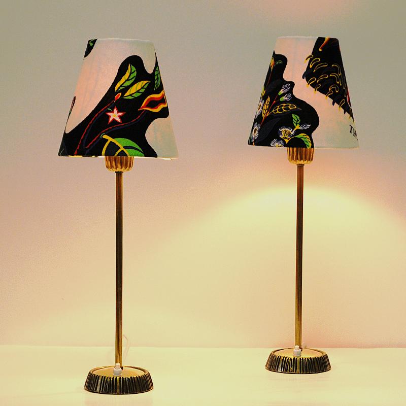 Pair of table lamps in brass designed by Sonja Katzin and produced by ASEA in the 1950s, Sweden. Beautiful patina and gorgeous design with carved stripe patterns on the brass base. Lightbutton placed on the base. Lampshades with Josef Frank fabric.