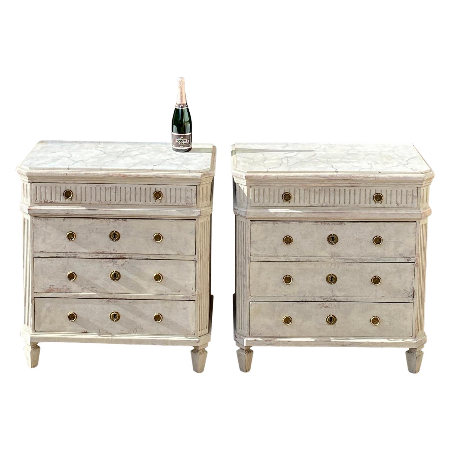 Pair Of Light Grey Gustavian Chest of Drawers With 3 Drawer Dressers, Brass Hardware and with Faux Marble Tops.