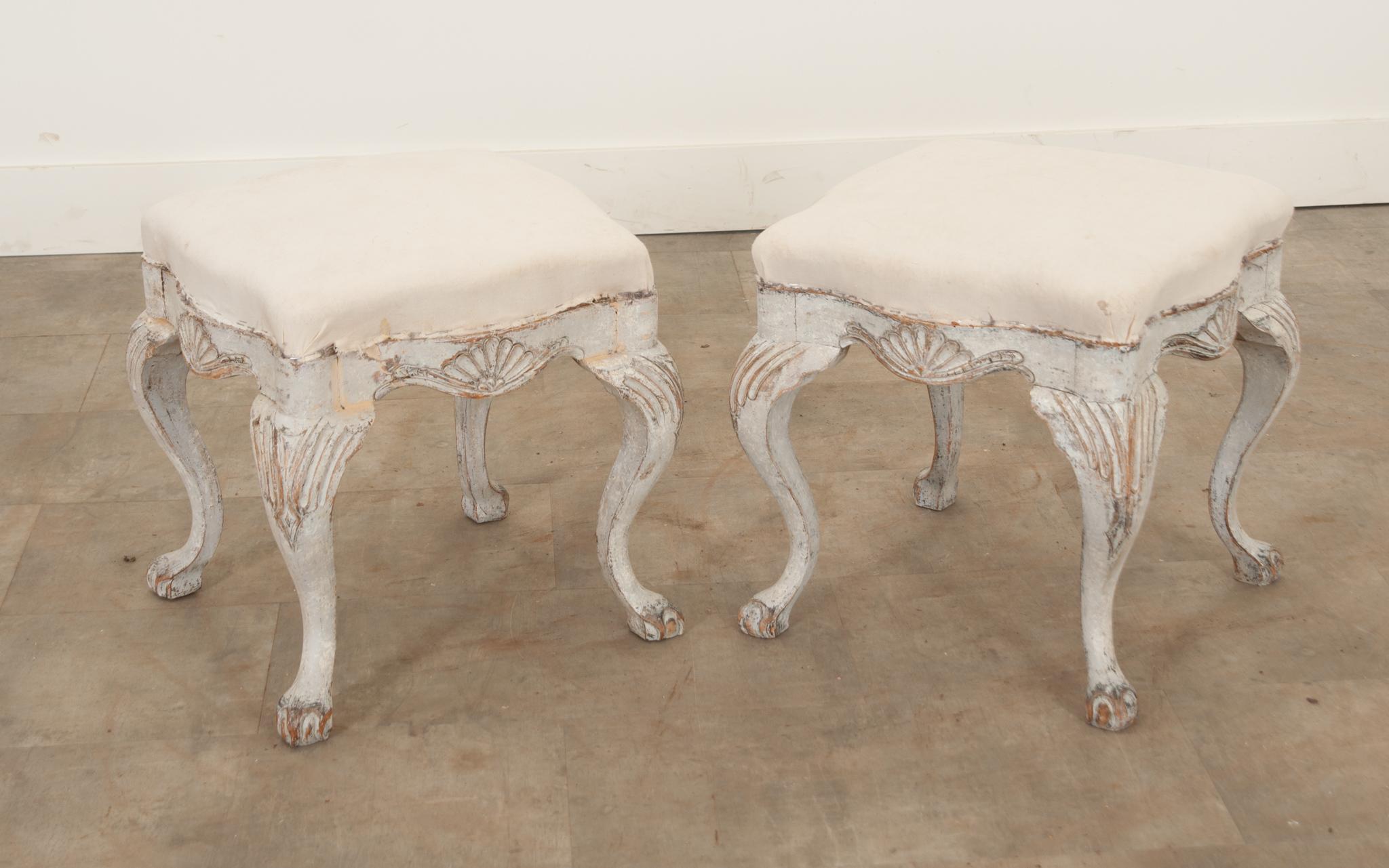 This darling pair of stools are the perfect way to spruce up any interior. Covered in a cream muslin fabric, they are ready to be upholstered in whatever fabric you love best. The wonderfully worn painted finish adds a great texture and patina to