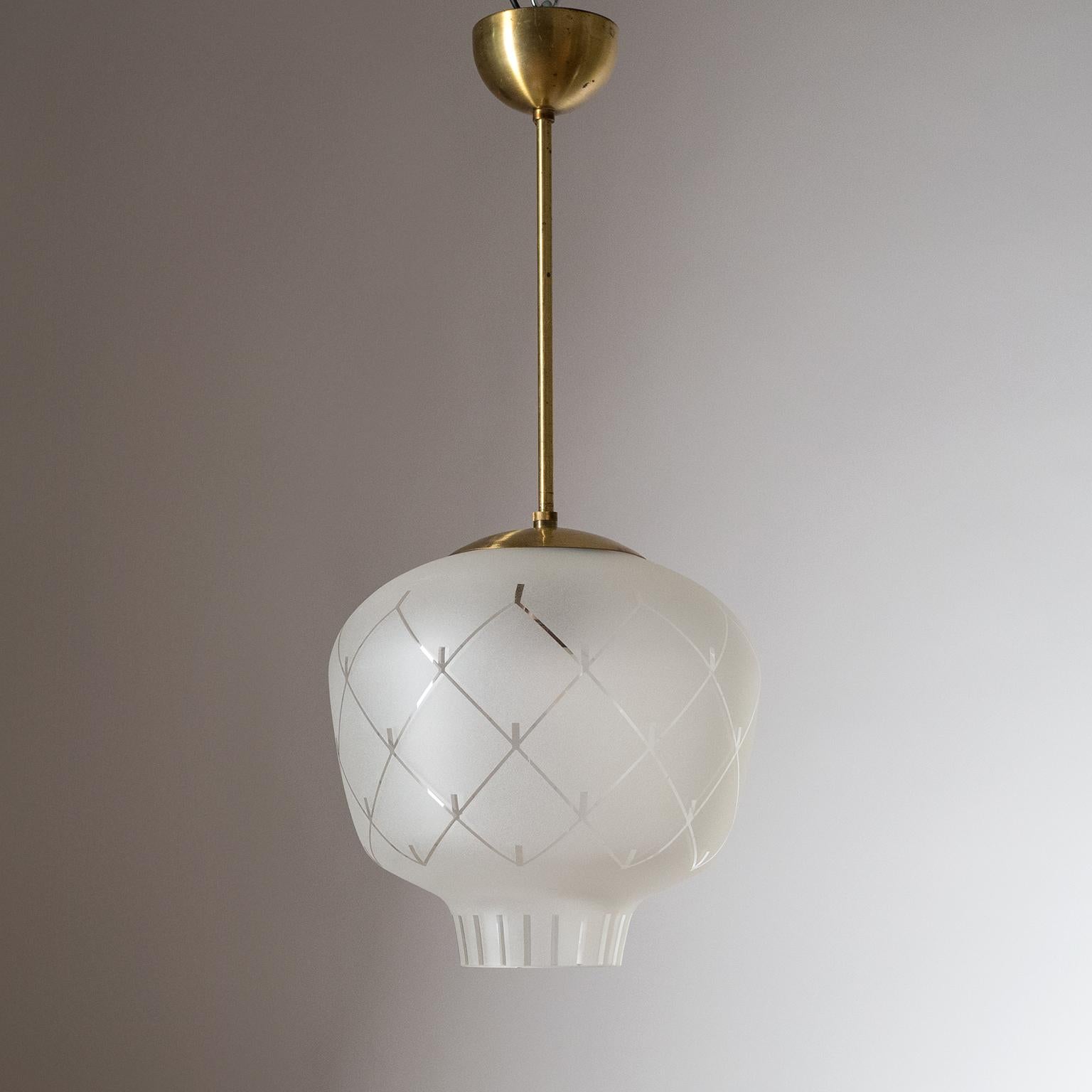 Swedish glass and brass pendant, late Art Deco, 1940s. A lovely shaped blown glass diffuser with a frosted geometric pattern and satin brass hardware. Fine original condition with a light patina on the brass. One original brass E27 socket with new