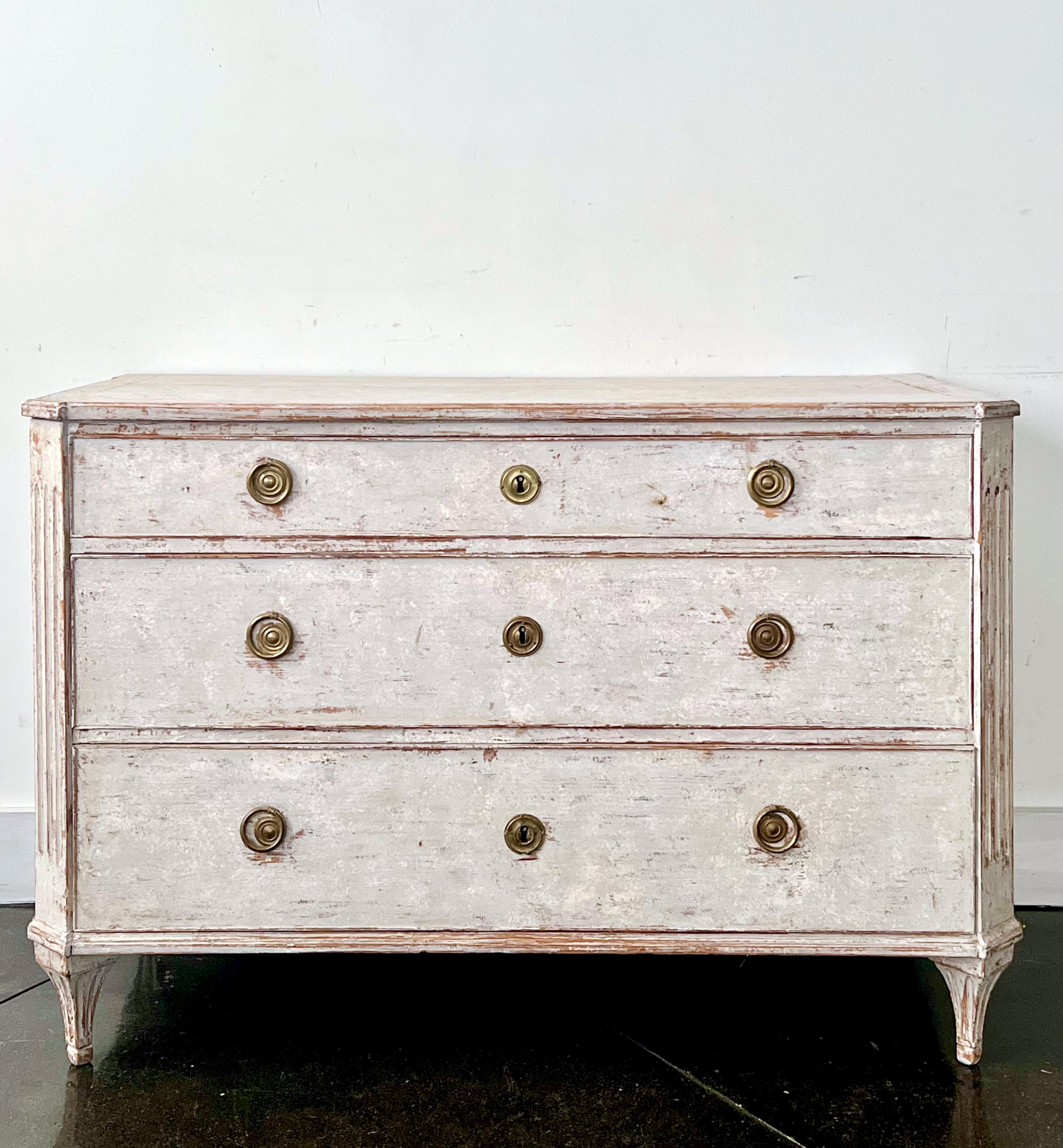 A Charming, large Swedish Gustavian period chest of drawers with original hardware and in wonderful worn lightest of light blue paint.
Canted posts with fluted details, handsome original large iron handles on the side panels and fluted, delicate