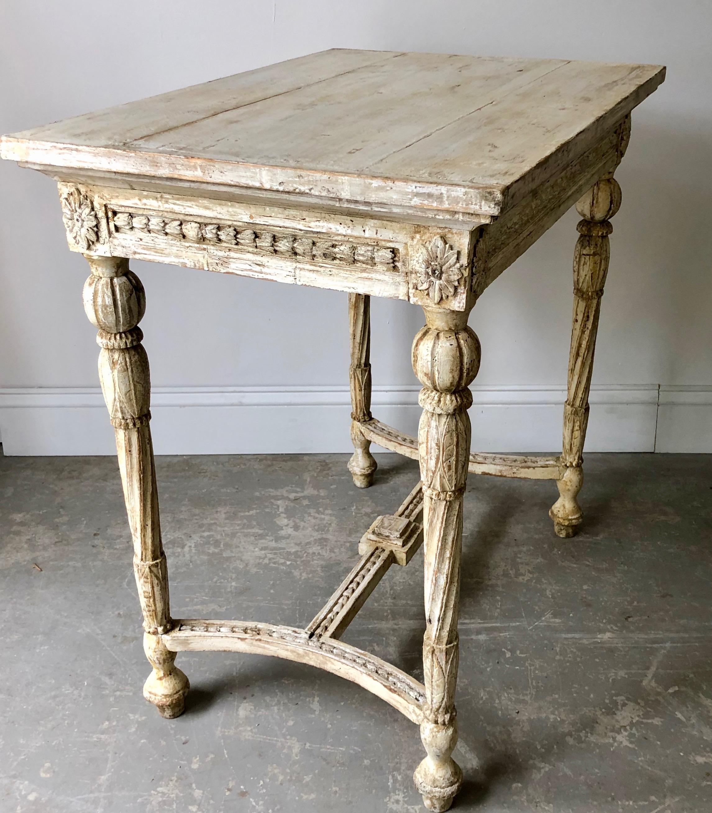 Charming Swedish Gustavian freestanding table with richly decorated with scrolling carvings to all four sides of apron and wonderful tapering carved legs with flower motifs and saltire strecher.
Sockholm, Sweden, circa 1820.
Surprising pieces and
