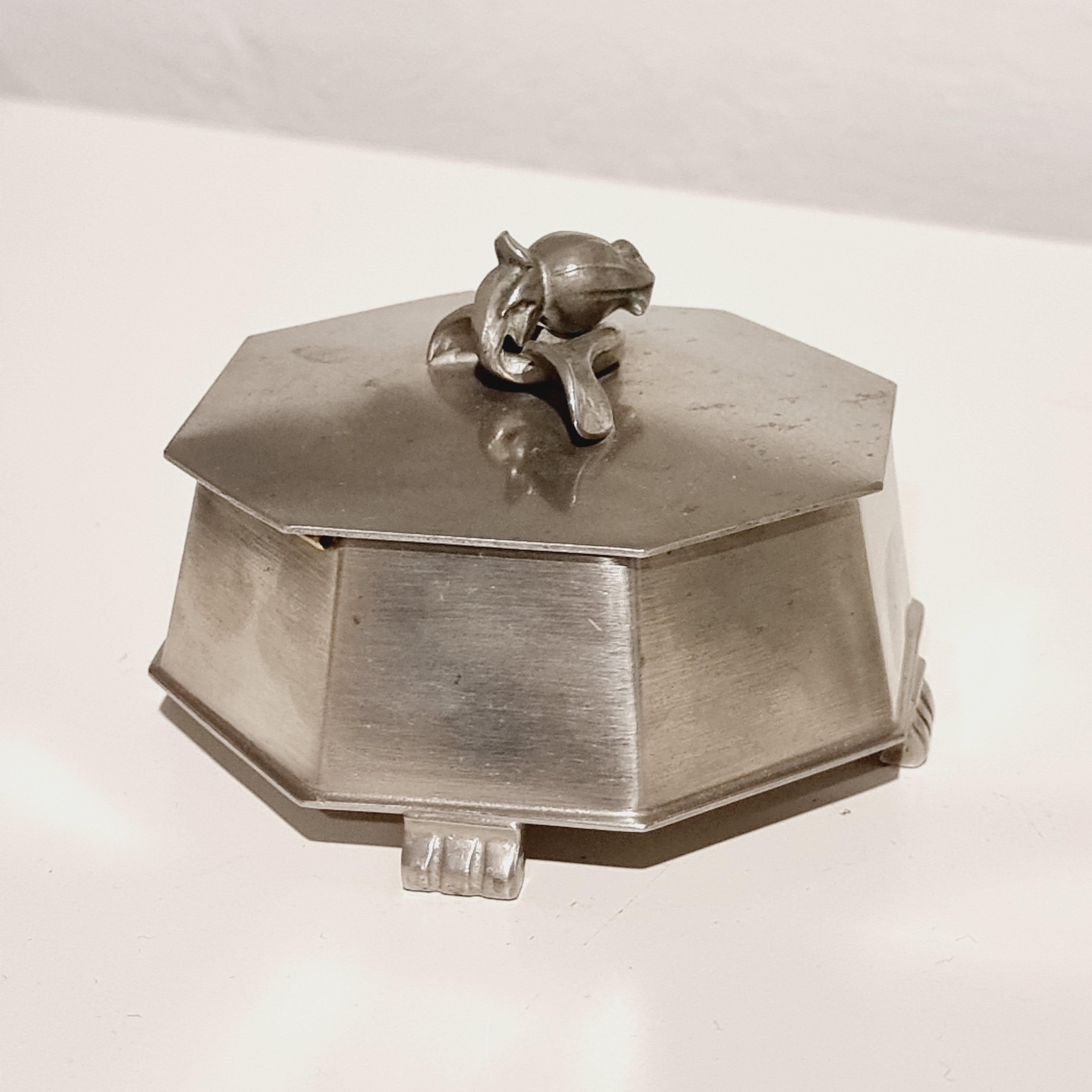 A rare pewter box with decor of rose on lid. Made by court jeweler CG Hallberg, Sweden 1936 (K8). 

With hallmarks. In good condition, smaller signs of age and wear. 