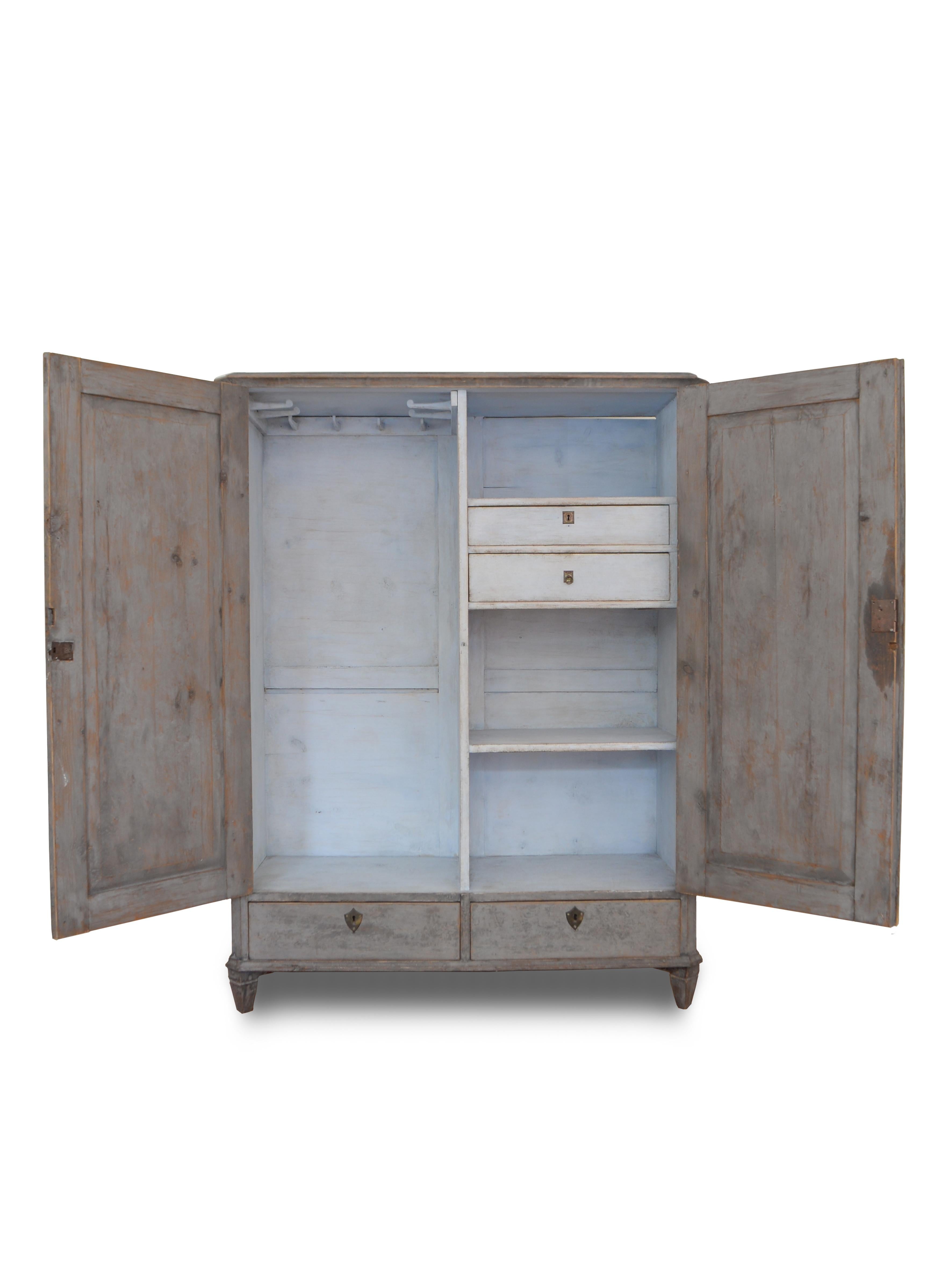 Antique Pine cabinet from Sweden made during the last years of the 19th century, around 1880.
The color of this beautiful cabinet is grafit gray with an rustic surface, the inside is painted light blue the same way, traditional handpainted whit an