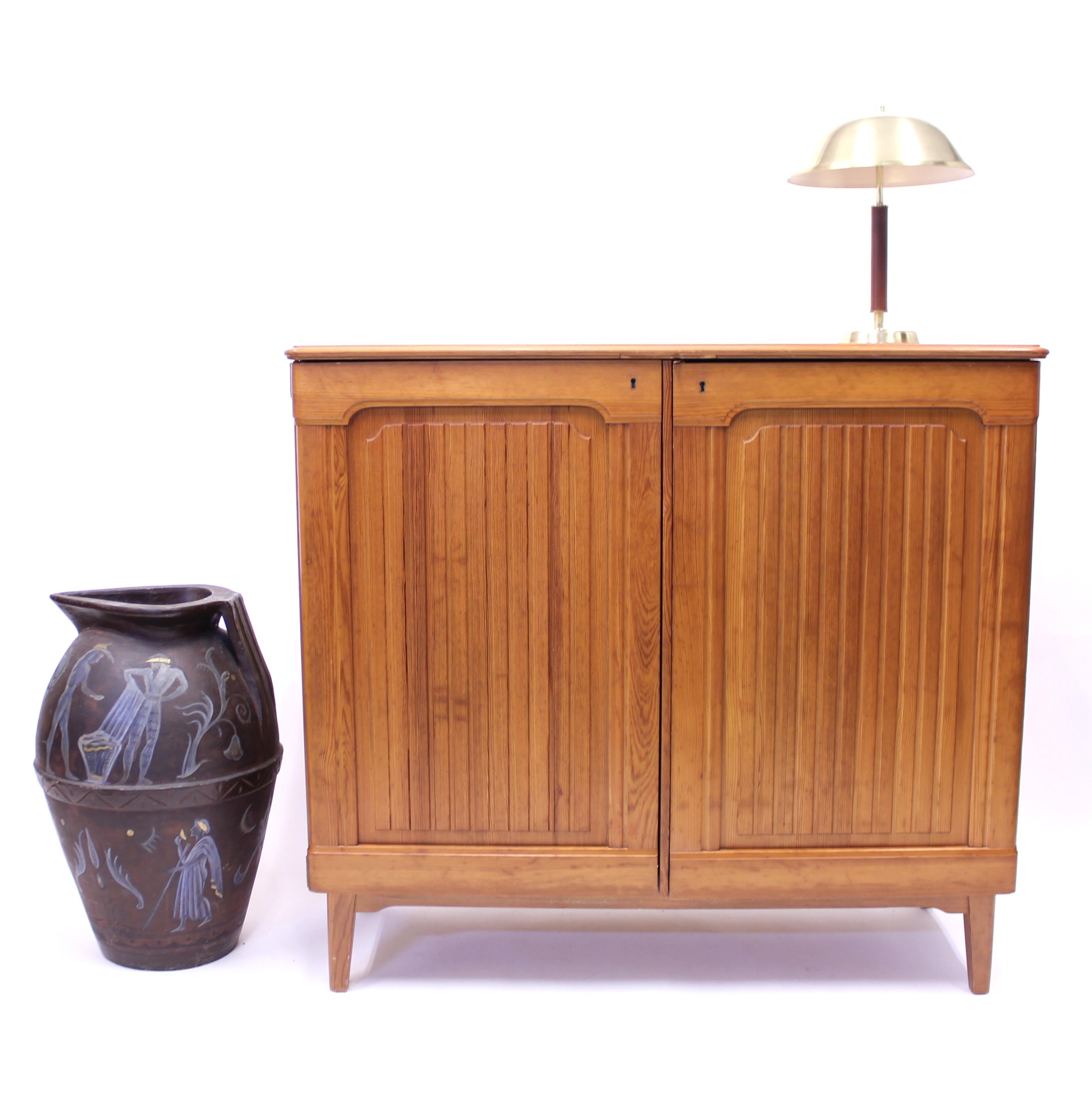 Rare Swedish midcentury pine cabinet manufactured by Svensk Fur and most likely designed by Göran Malmvall who has done most of the designs for the firm. Made in te 1950s. A very typical so called 