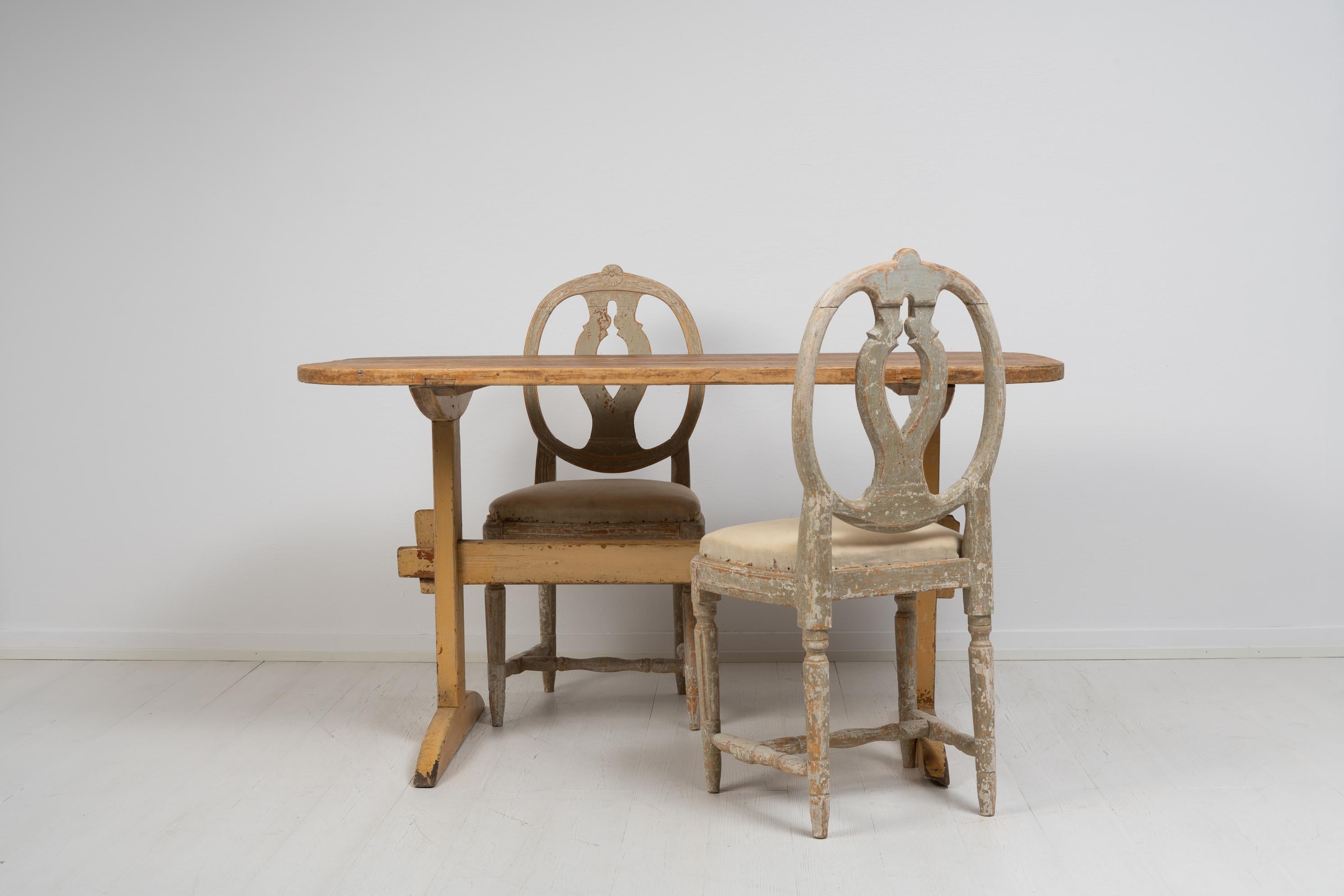 Swedish country home dining table in folk art. The table is well suited to hold two chairs on each of the longer sides. Made during the 1820s to 1830s the table is solid pine with a heavy table top. The table is a solid staple that has stood the