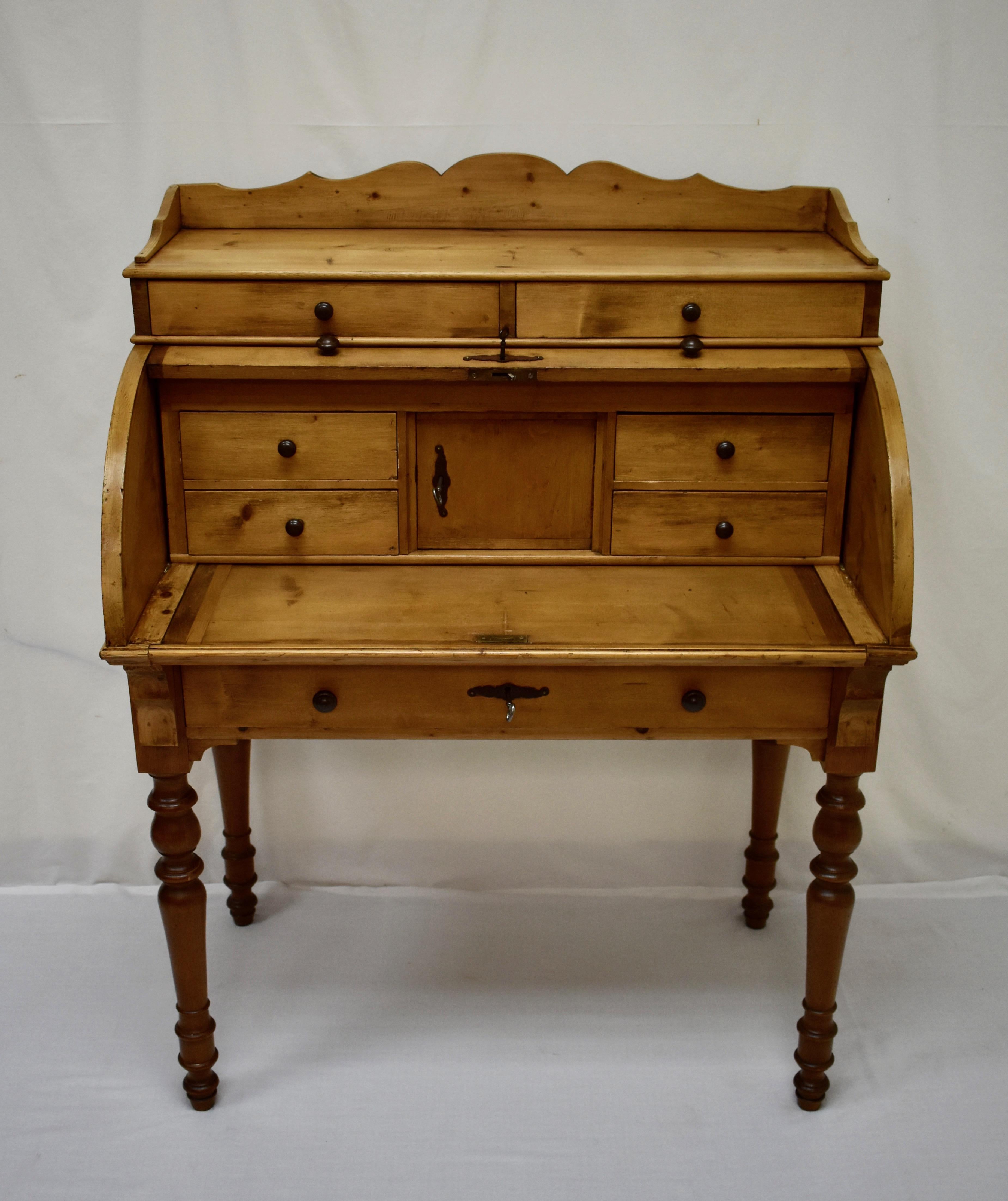 This splendid Swedish writing desk is one of the nicest antique pine cylinder rolls we have ever offered for sale. It has spent the last twenty years in this dealer’s personal collection.
A top shelf bordered by a scalloped gallery has two shallow