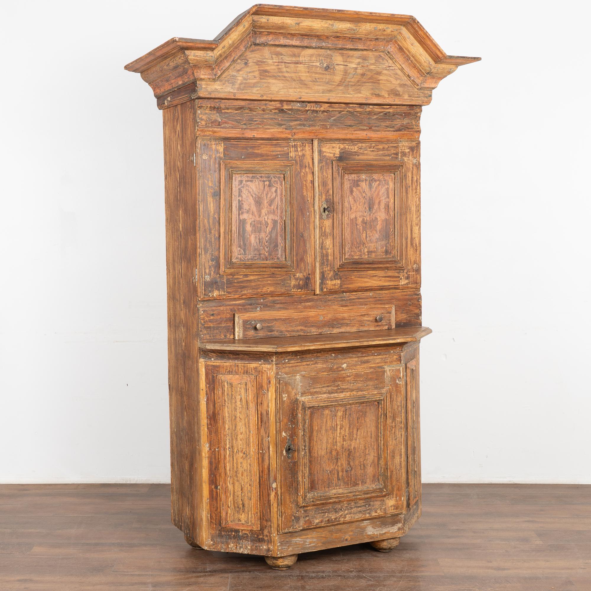 A wonderful example of Swedish country craftsmanship from the Dalarna region.
This cupboard has a soft, warm aged patina due to the original painted being rubbed/scraped down to the natural pine below. Look closely and you will see the faint remains