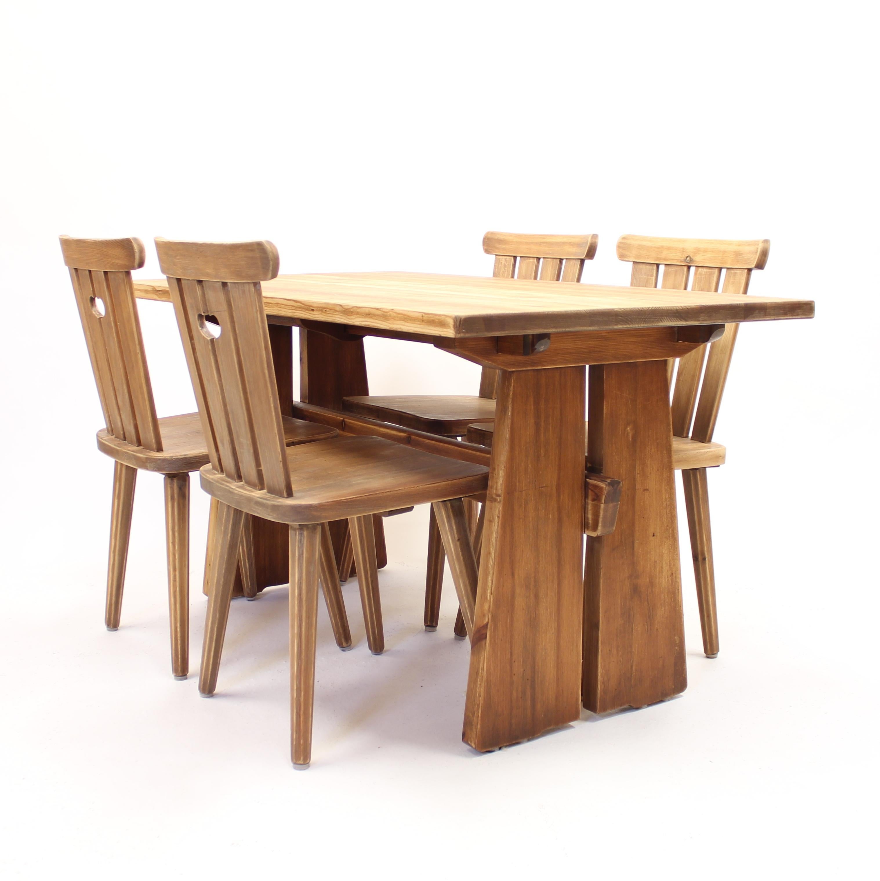 Swedish mid-century pine dining set including four chairs and a dining table with one extra leaf. A very typical so called 