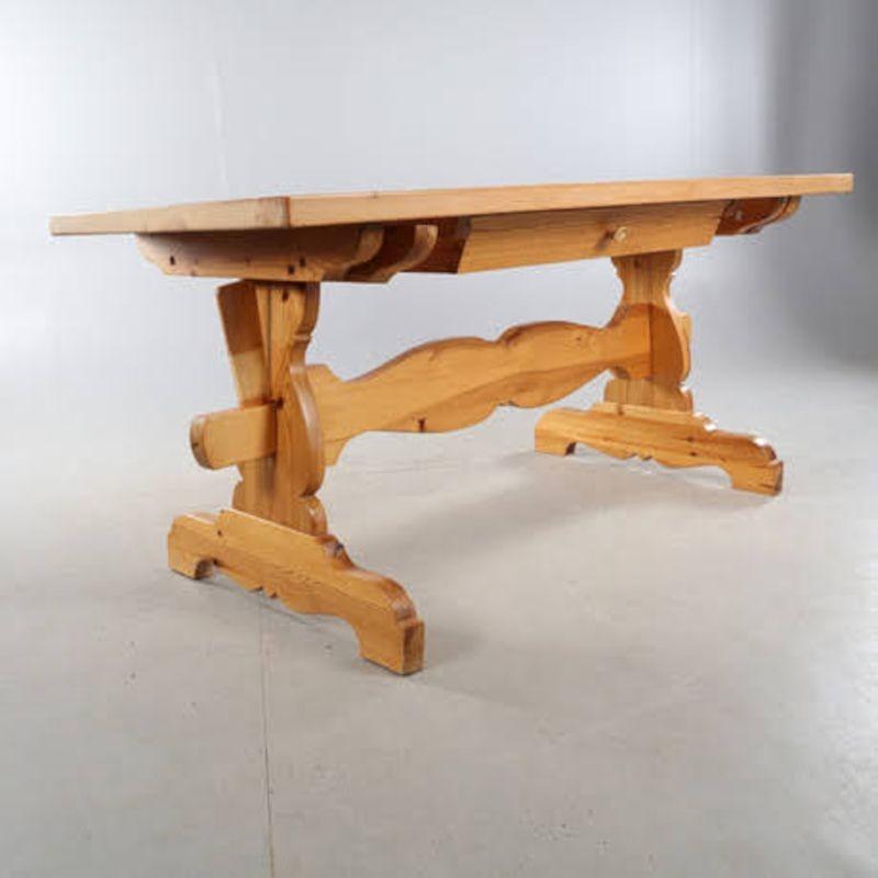 1900's Swedish pine farm table with simple carved trestle legs & solid pine top. This style of 