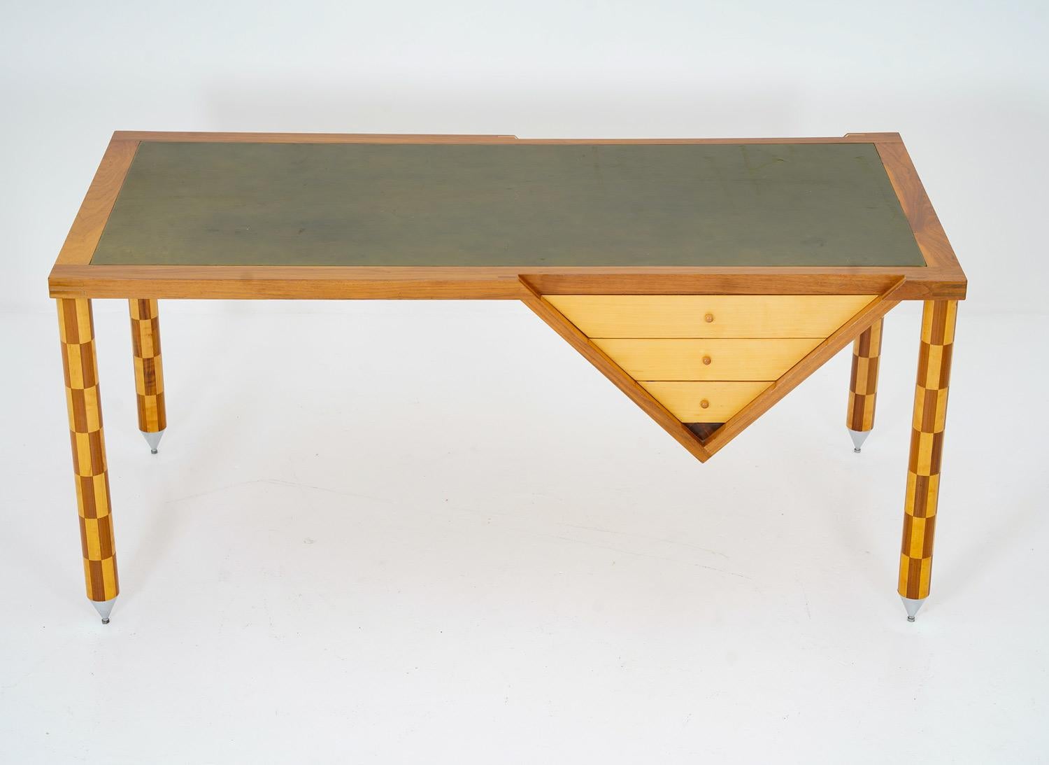Incredible desk in wood and leather by Swedish cabinet maker, 1980s.
The desk consists of a tabletop covered with green leather. Three drawers, shaped like a triangle are integrated with the tabletop, combining design and functionality. The desk is