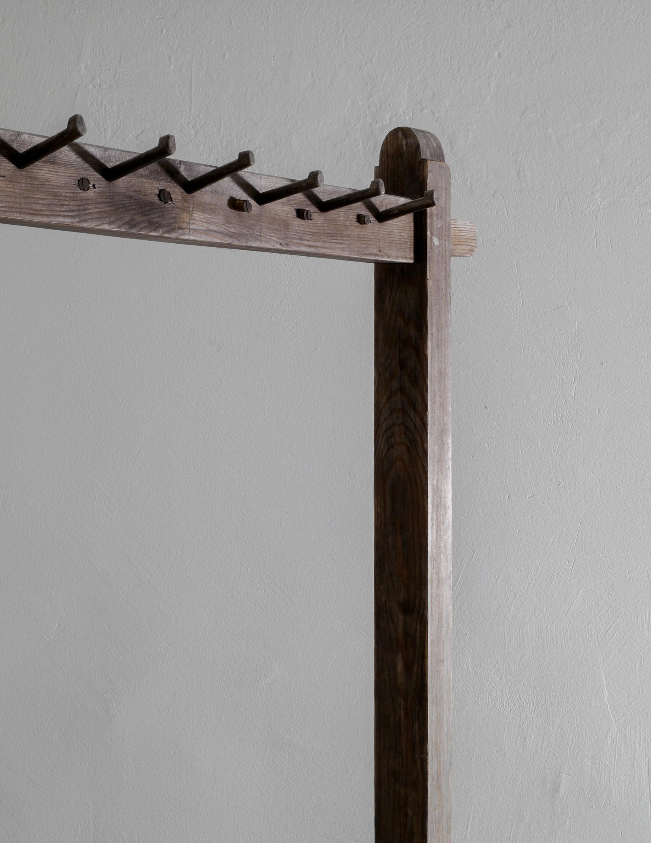 Rare coat or clothing rack produced in Sweden by unknown designer and fits perfectly into a wabi sabi style interior. In good overall condition considering its age and showing nice and beautiful patina with a lot of character. One hanger is missing