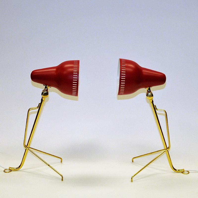 Rare metal and brass desk lamp pair with adjustable neck by Falkenberg Belysning - Sweden 1950s. Red laquered lampshades with cone shaped shades. White inside, pierced edges for a lovely light flow and brass stom with matching V shaped legs. Light