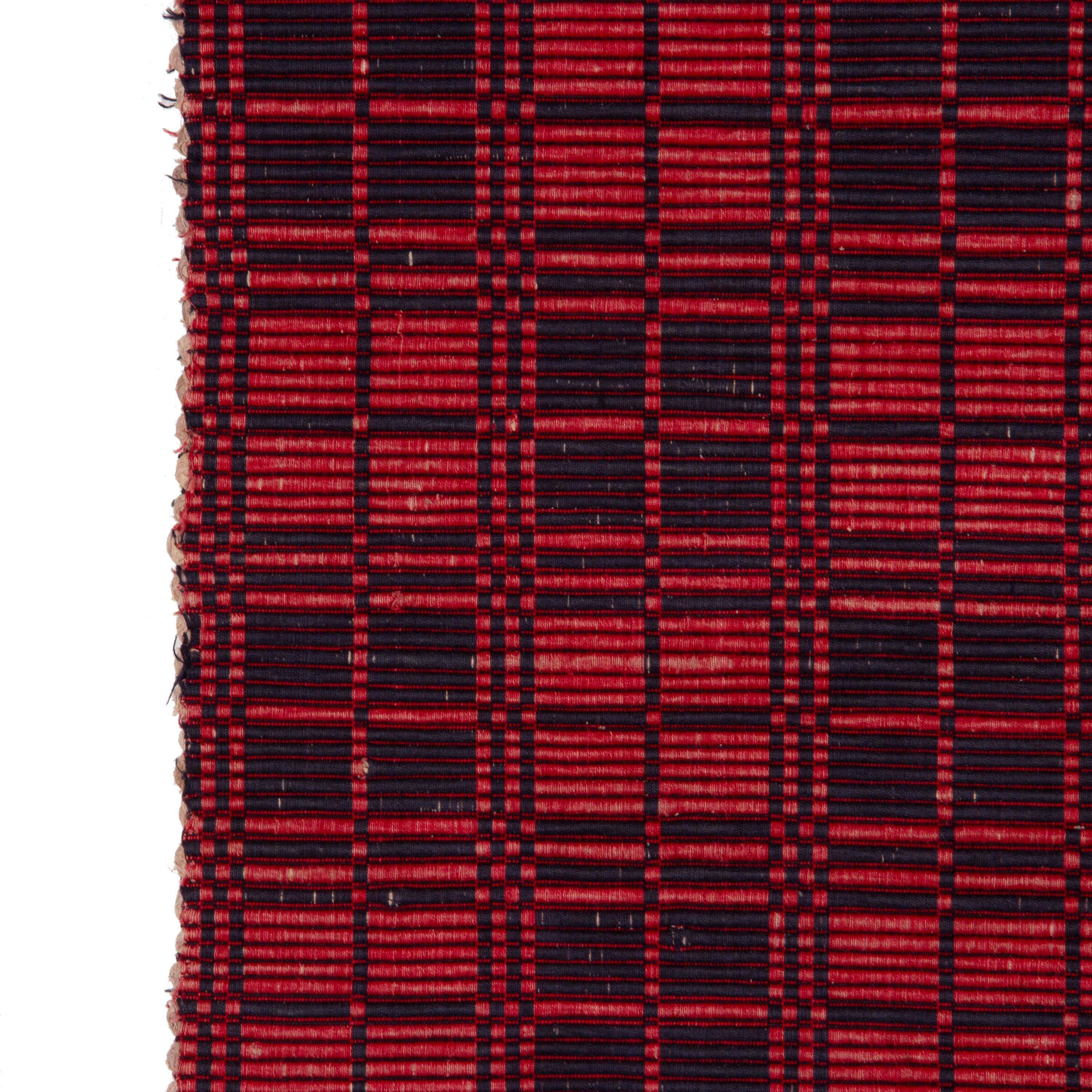 Swedish handwoven rip rug, 1940-50.
This rug has a long thin form, ideal for use as a runner. It features a dense geometric design in attractive shades of red and navy.