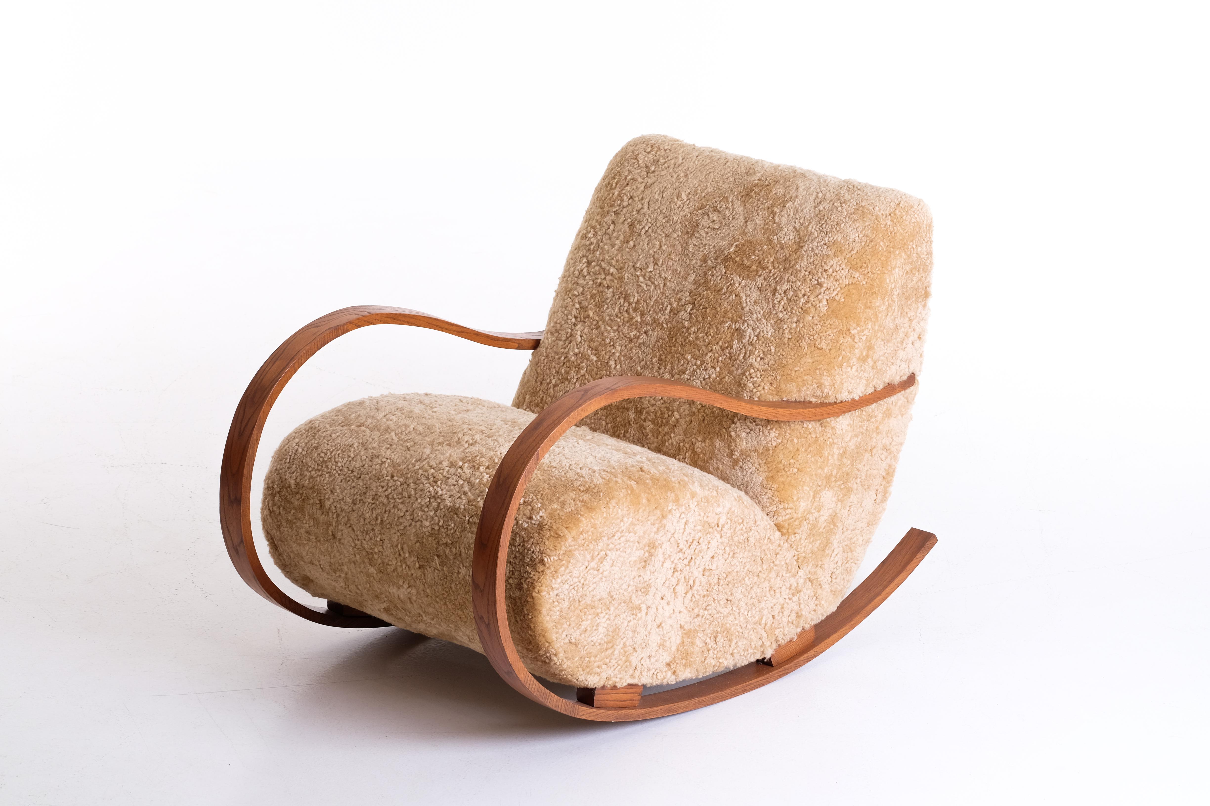 Reupholstered in honey colored sheepskin. Produced in Sweden, 1940s.

