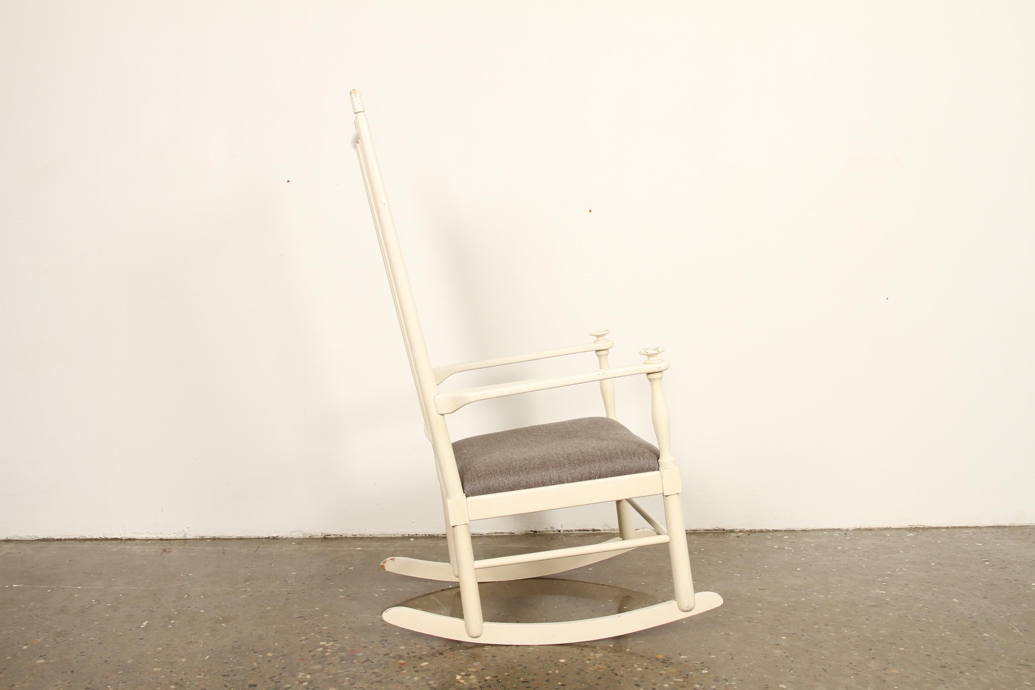 Vintage rocking chair from Swedish designer Karl-Axel Adolfsson. Made by Gemla in the 1960s. Original paint and new upholstered seat in grey wool.