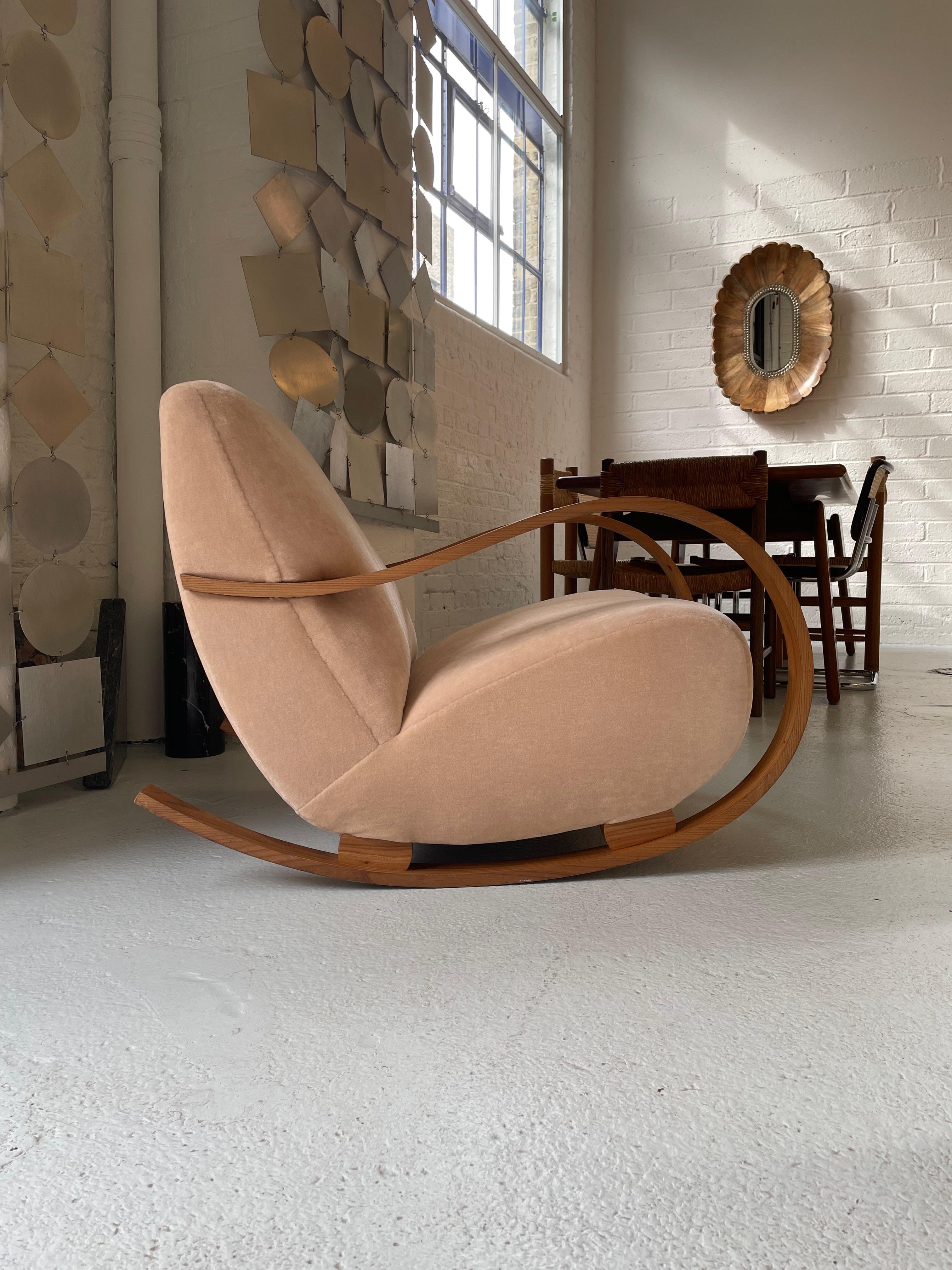 This art deco danish modern rocking chair was produced in the 1940s. It is made of bentwood and features wooden components and spring seats. Completely restored and reupholstered in cotton velvet.
Very comfortable with an appropriate level of give,
