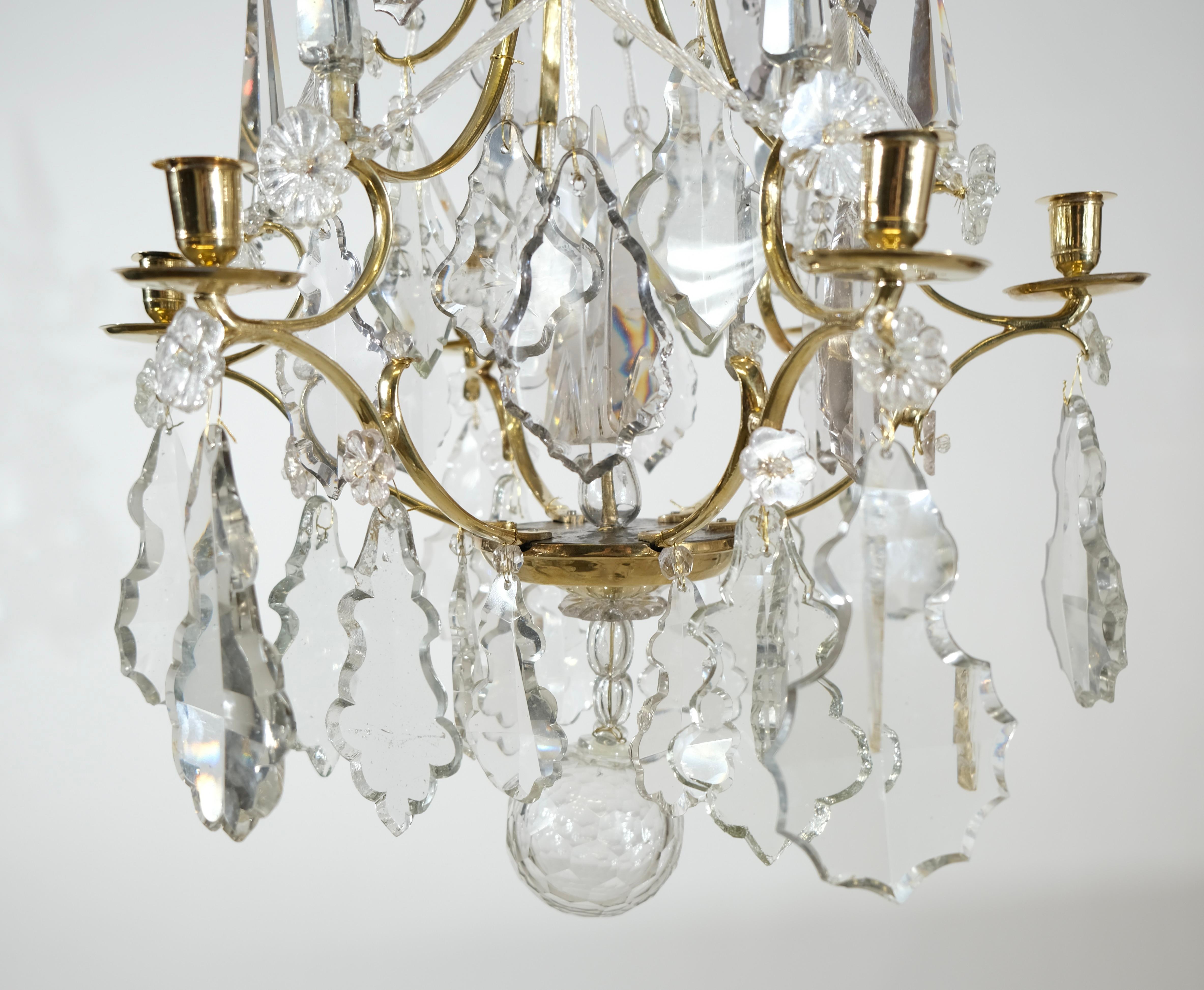 A fantastic small Swedish Rococo chandelier with wonderful proportions made in the second half of the 18th c. The pear shaped metal frame is made of cast brass. In it hangs cast, and cut crystals that are shaped as leaves. There is also a 