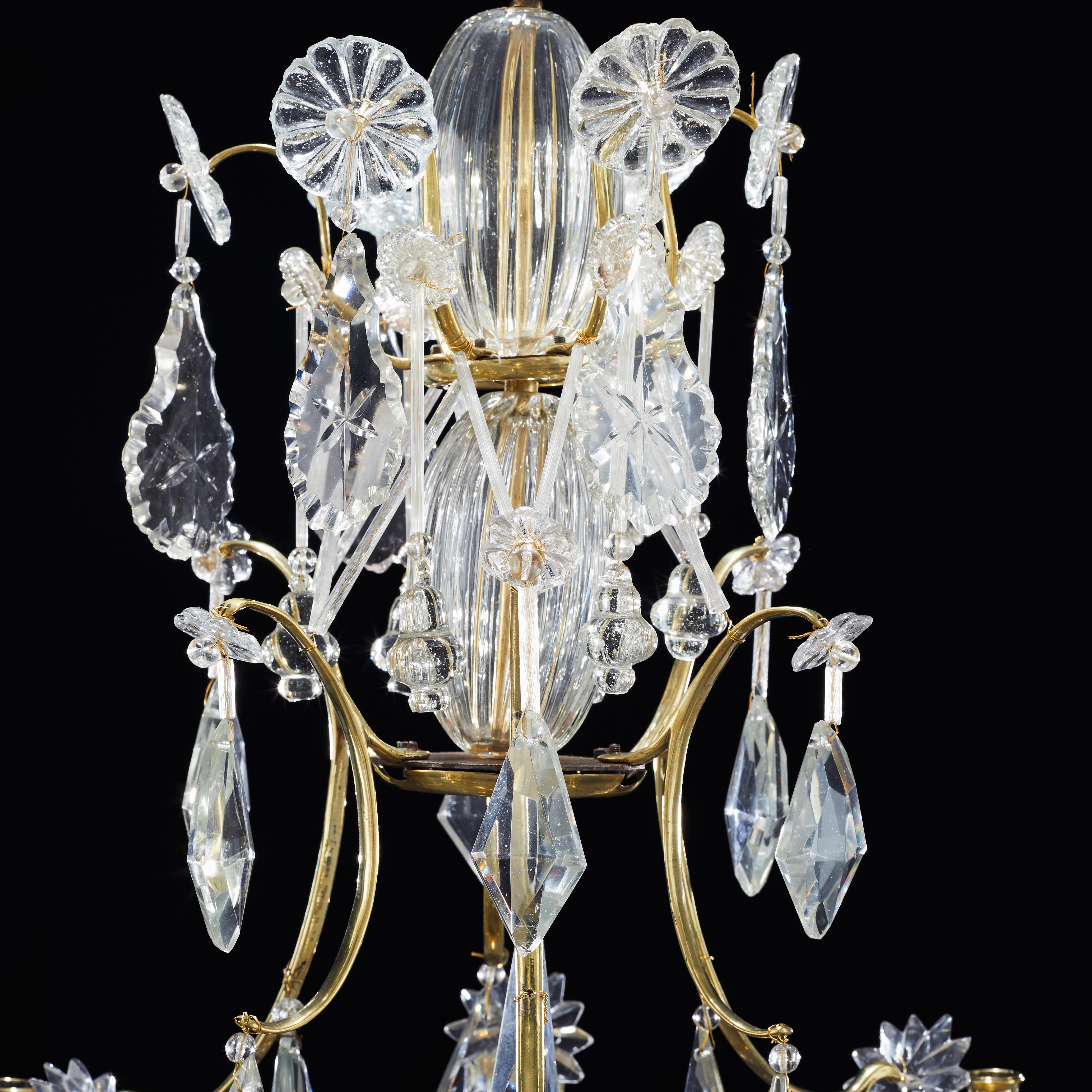 A Swedish 18th century 6-light Rococo crystal and gilt brass chandelier made in Stockholm, circa 1760-1780. It is unusual that Swedish Rococo chandeliers have a gilt cage.