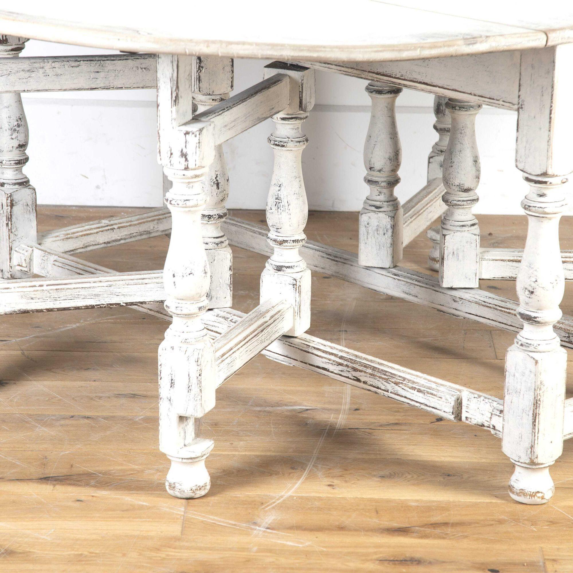 Period Swedish Rococo painted gate-leg table.
This large table features an oblong top with two drop leaves.
The top is supported over a substantial base of turned legs with block joints and stretchers. 
Retaining old white paint which has gently