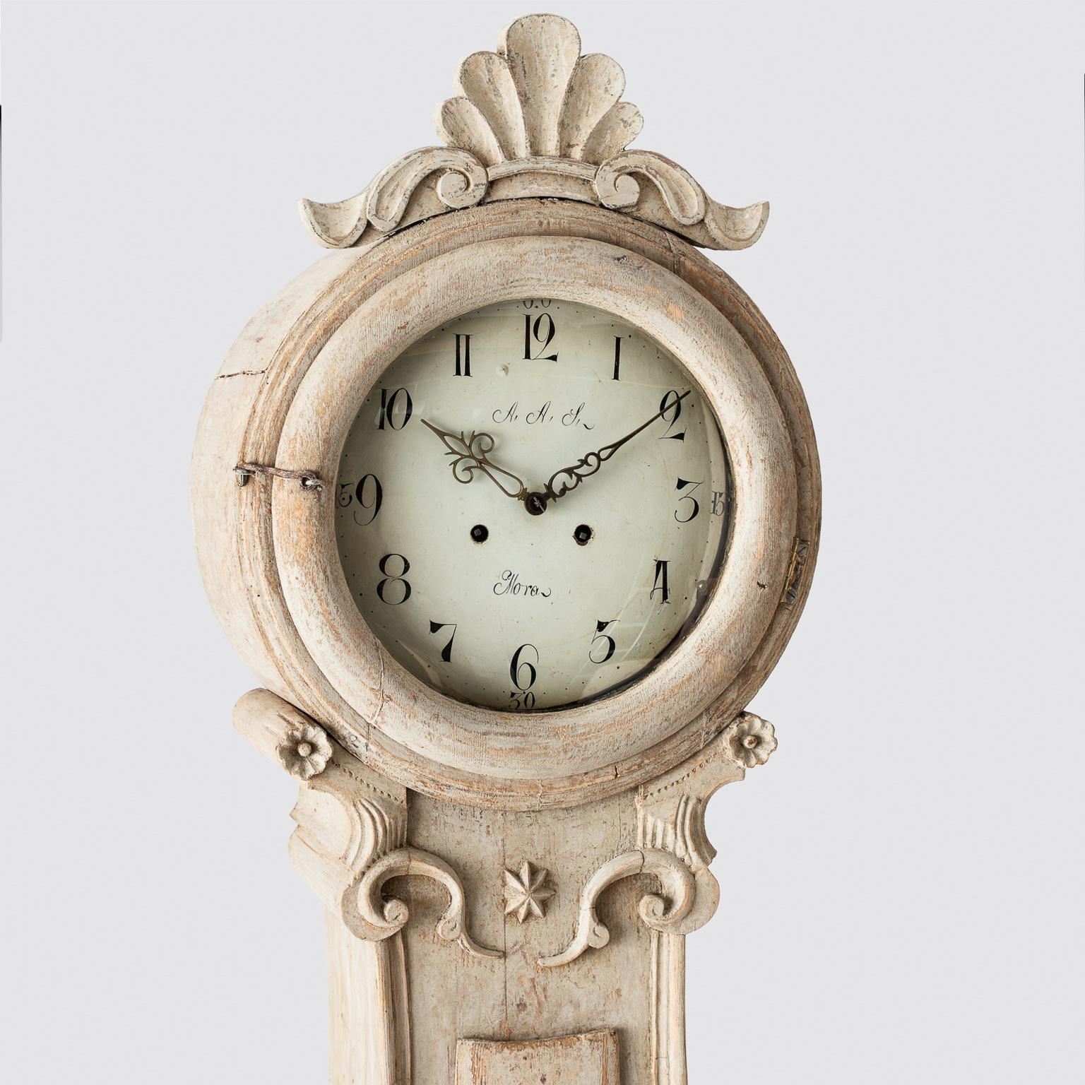This Swedish Mora clock is typical of the rococo style with an elaborate crown in the form of a shell surrounded by other decorative details. The face of the clock is signed by Anders Anderson, one of the most highly respected clockmakers at the