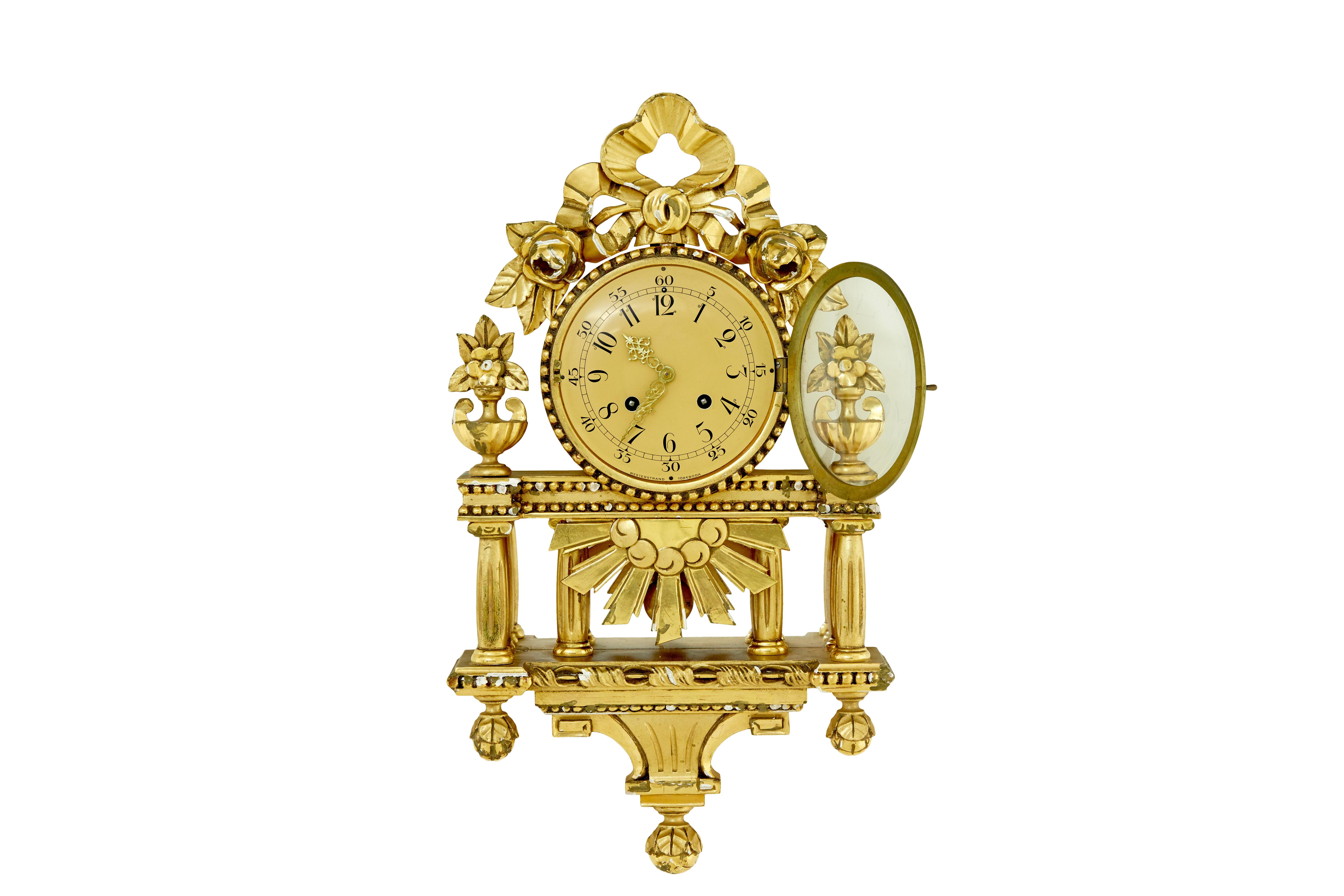 Swedish rococo revival gilt wall clock by Westerstrand circa 1950.

Good quality rococo influenced clock by well known Swedish maker westerstrand.

Fitted with a twin train 8 day movement and original pendulum. Enamel clock face with arabic numerals