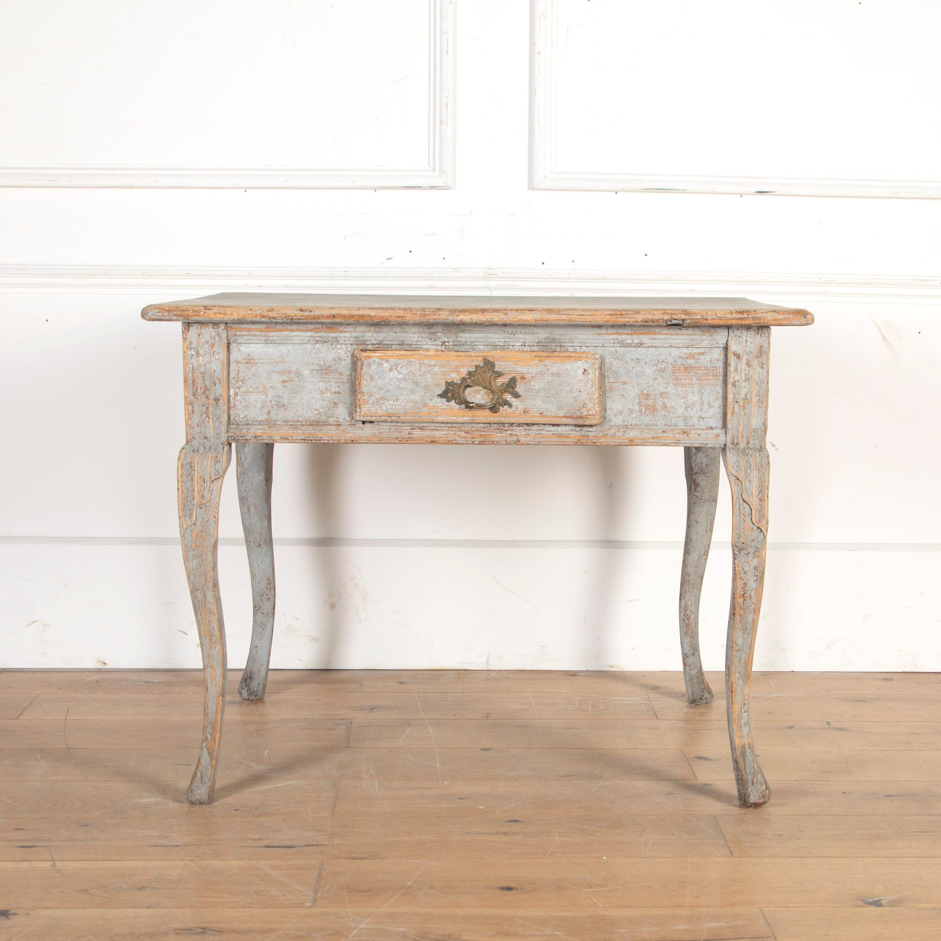 Swedish 18th Century provincial side table in the rococo style.

This elegant table has charming small proportions and offers a single drawer to the frieze. It is supported on graceful cabriole legs. 

It has later distressed blue paint and a