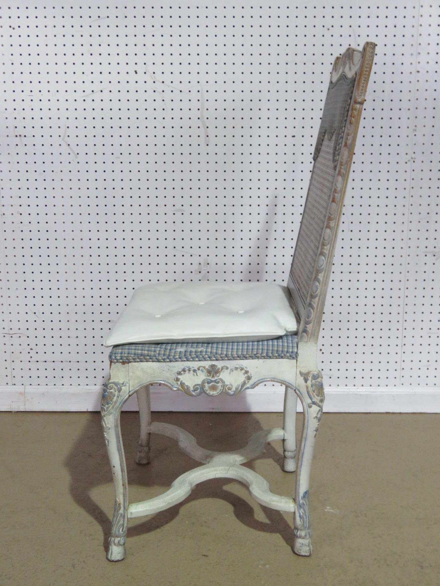Swedish Rococo style distressed painted desk chair with a caned back.