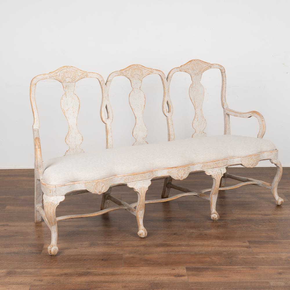 The gentle curves seen throughout this settee bench are reflective of Sweden's love of Rococo styling.
Curved backs, cabriolet legs, wavy stretcher and carved details all combine for a romantic look to this chair back settee.
The layered soft