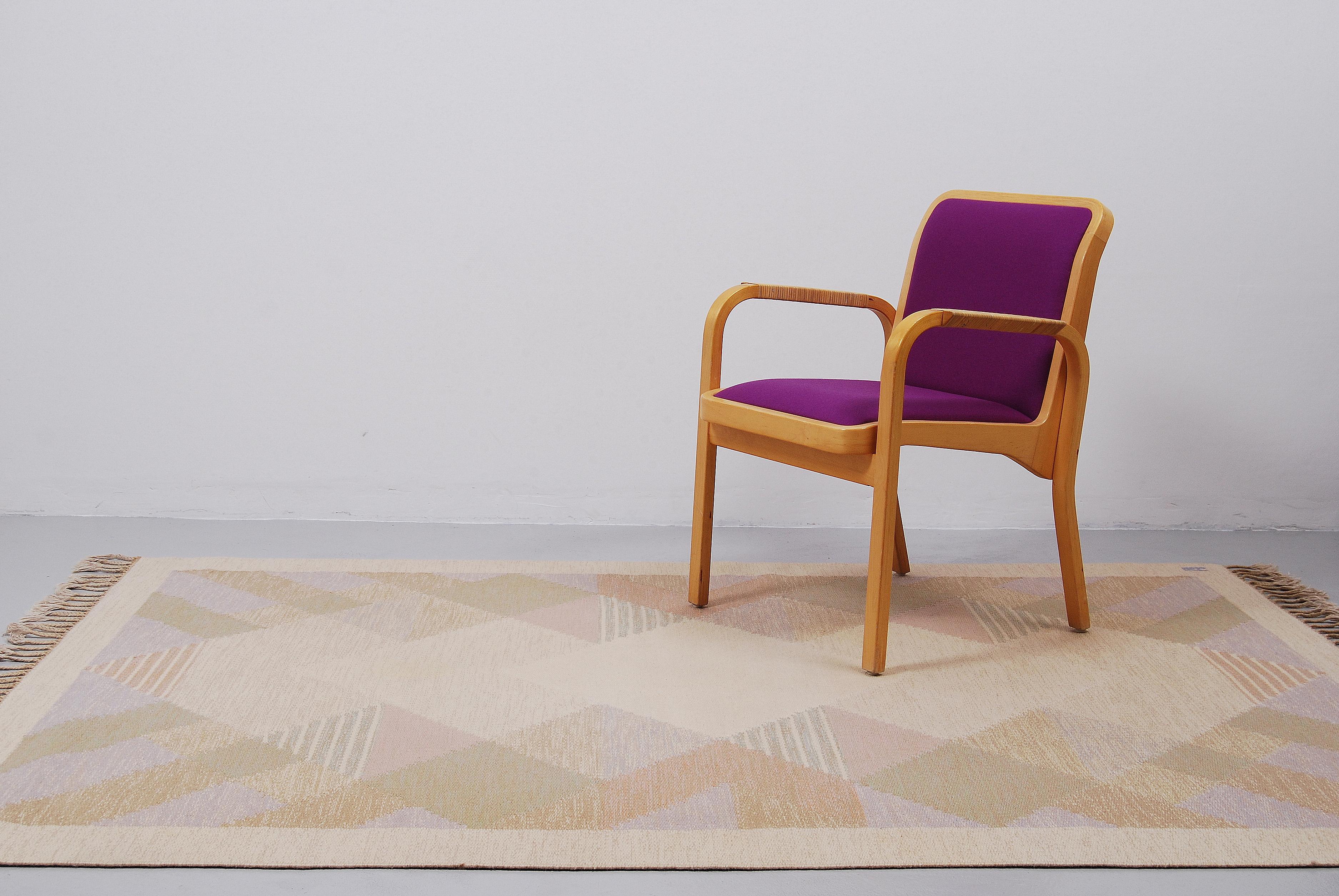 This flat-weave Rölakan carpet ”Aniara” was designed by Anna Johanna Ångström and made by hand in Sweden during the 1960s.This example with fields in different shades of purple, beige, brown, pink and green was woven in wool and signed ”Å” to the