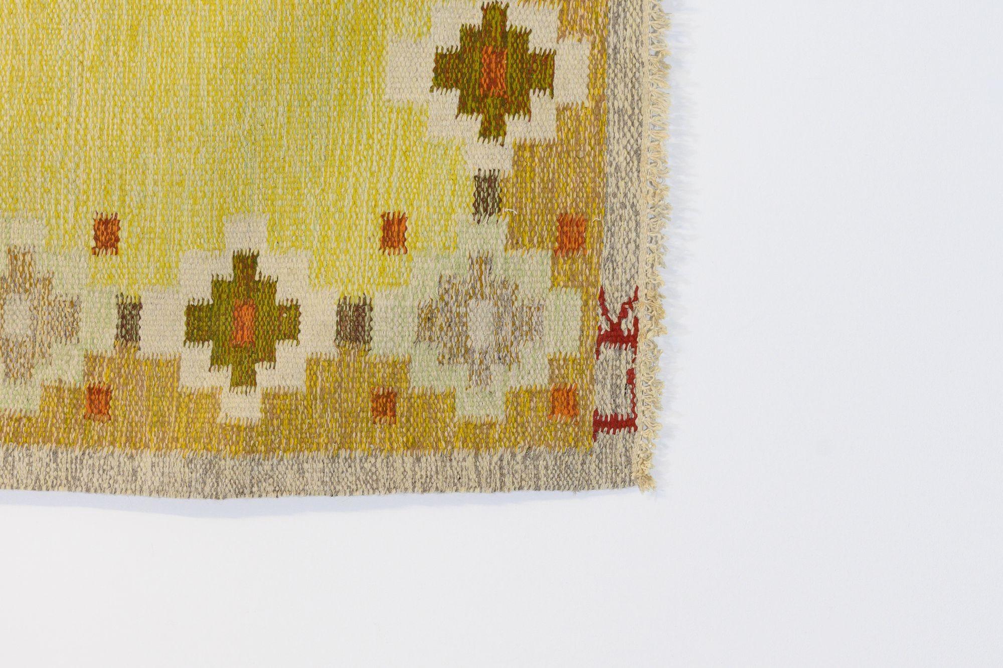 Mid-Century Swedish kilim in tones of yellows and orange, signed L.K. Circa 1960. All our carpets undergo a professional cleaning process. However, due to their age and previous life, some may exhibit minor signs of wear consistent with their