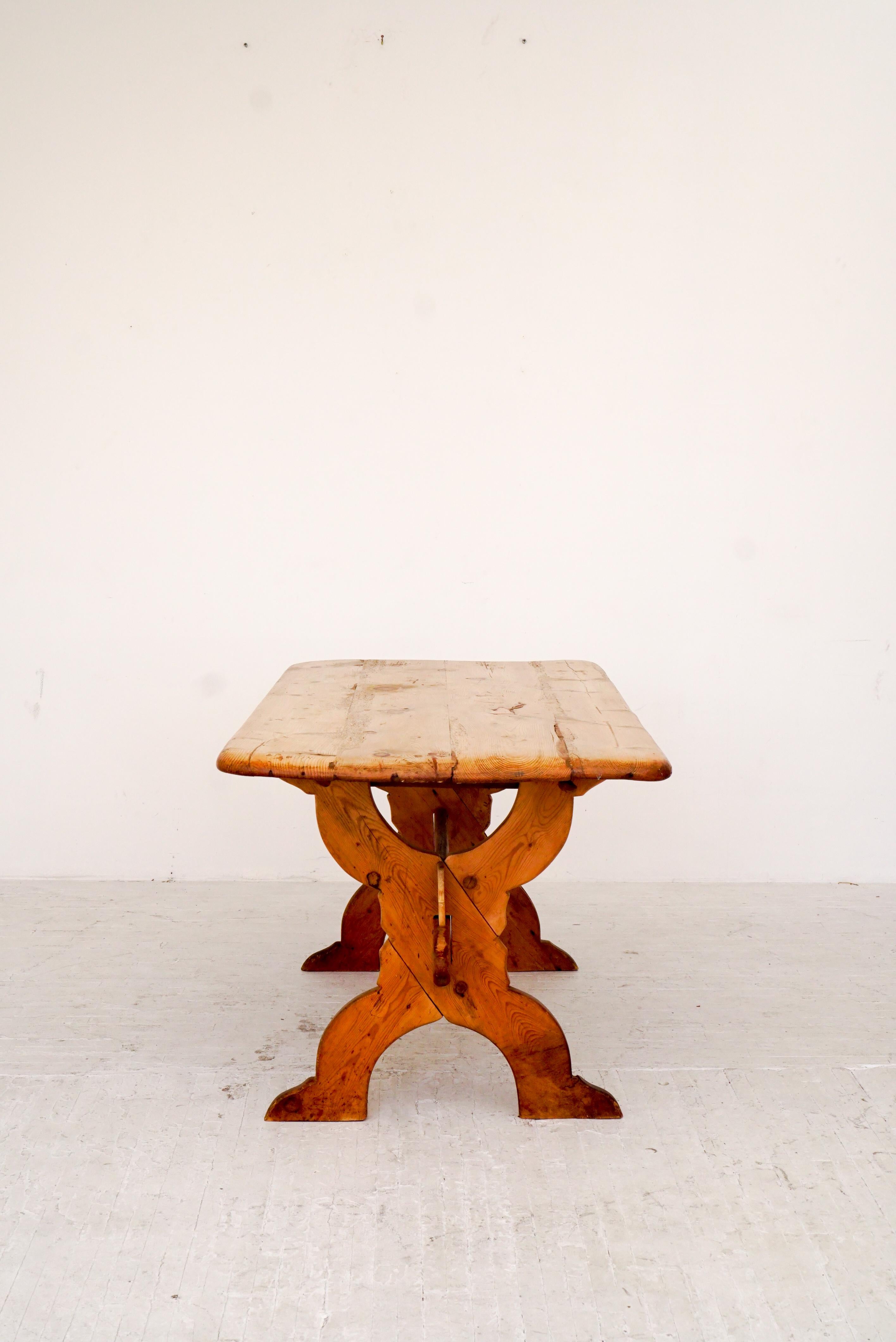 A 19th century antique pine table. Heavy patina from years of use and worn to perfection. Wood joinery and solid construction. Worm wood holes and knots.