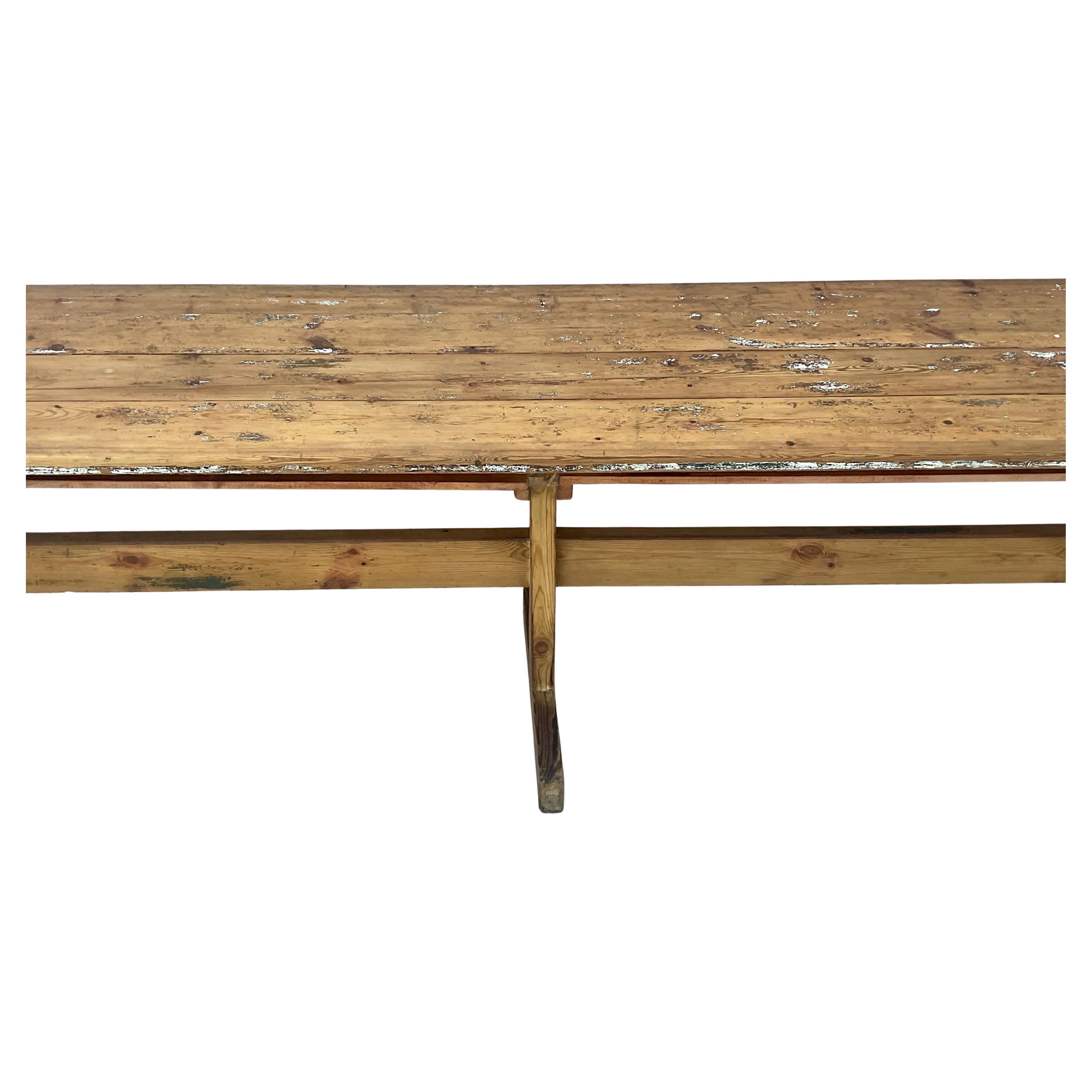 19th century Swedish Painted Pine Long Table with trestle base. Wonderfully worn patina with layers of paint on the top. Solid sturdy table. Can be used for dining, in an entry or hall and even as a large sofa table to add some real character to any