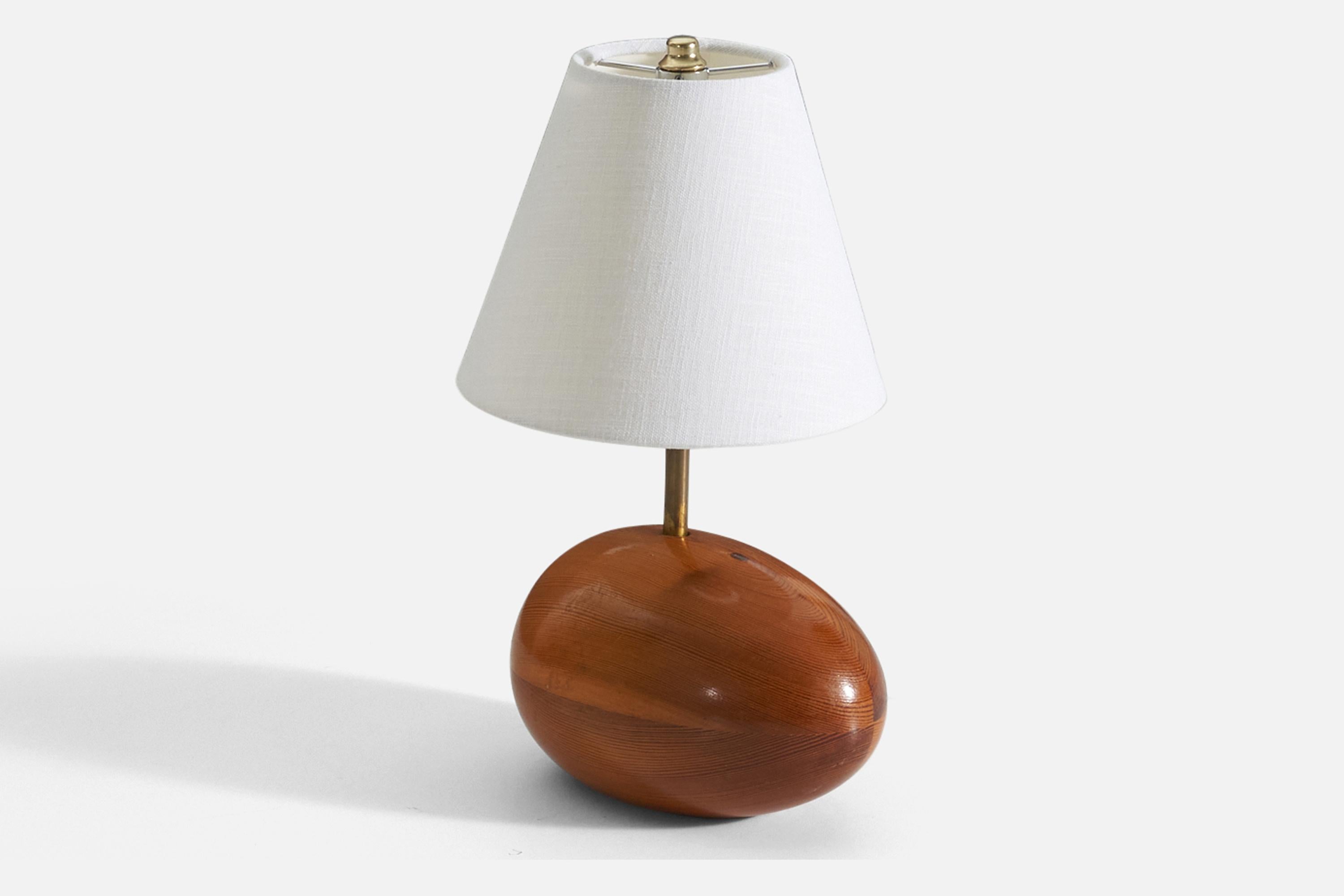 A table lamp. Base in solid pine. Brass neck. 

Stated dimensions exclude lampshade, height includes socket. Sold without lampshade.