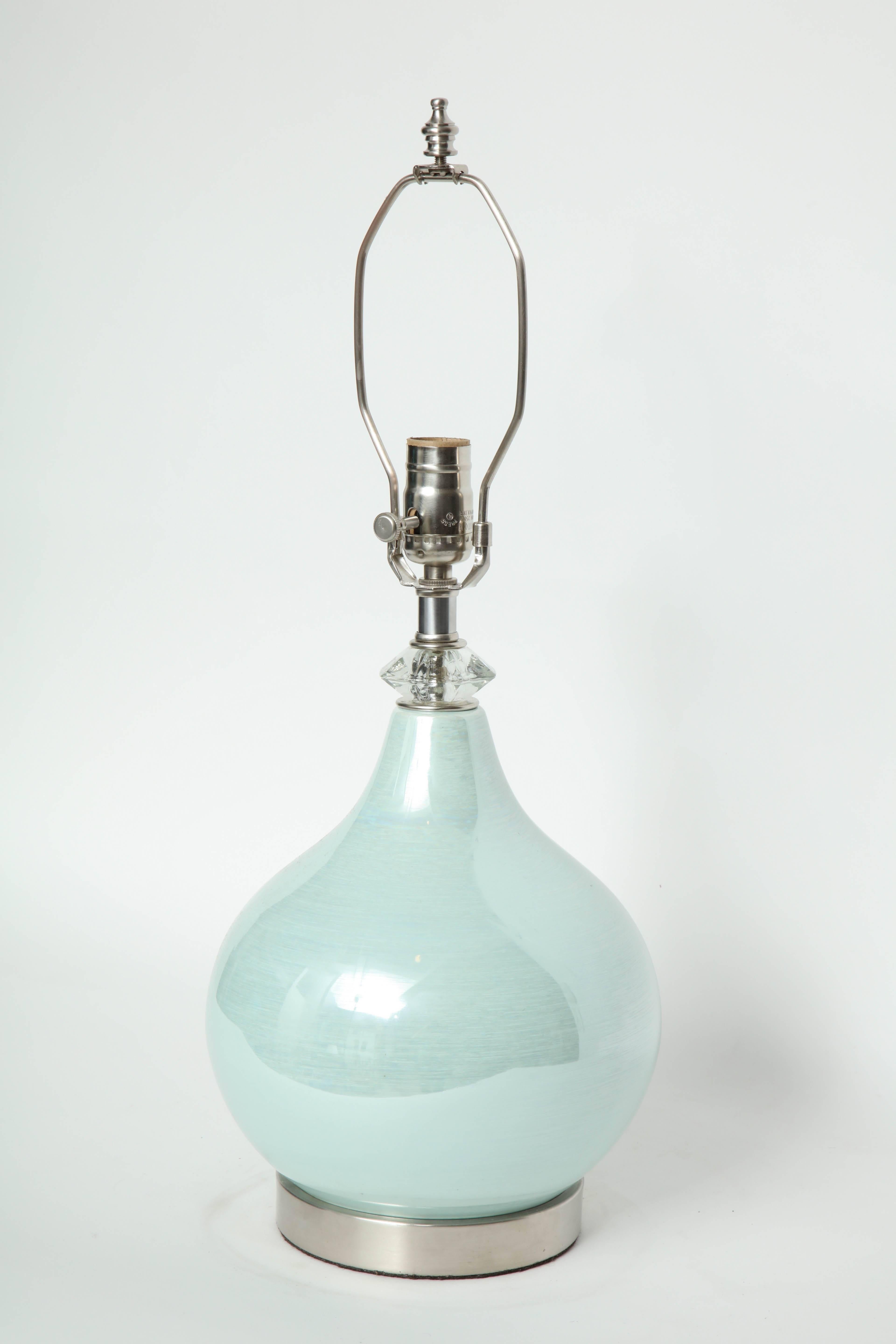 Pair of onion shaped orb porcelain lamps in a beautiful sea foam green glaze on brushed nickel bases and faceted crystal collar. Rewired for use in the USA. 100W max bulbs.