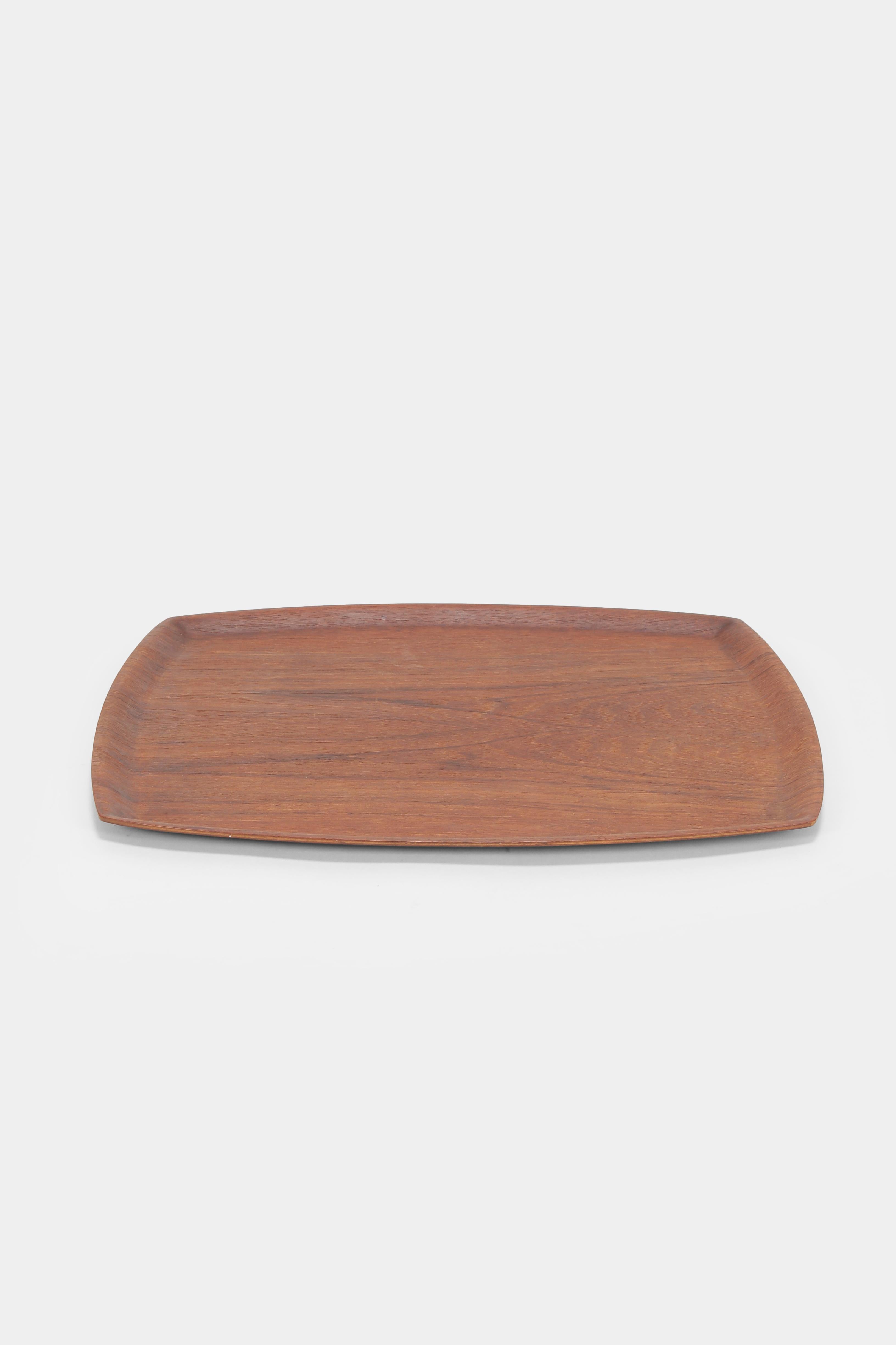 Serving tray manufactured in the 1960s in Sweden. Made of teak wood with slightly curved frames. Marked on the bottom with made in Sweden.